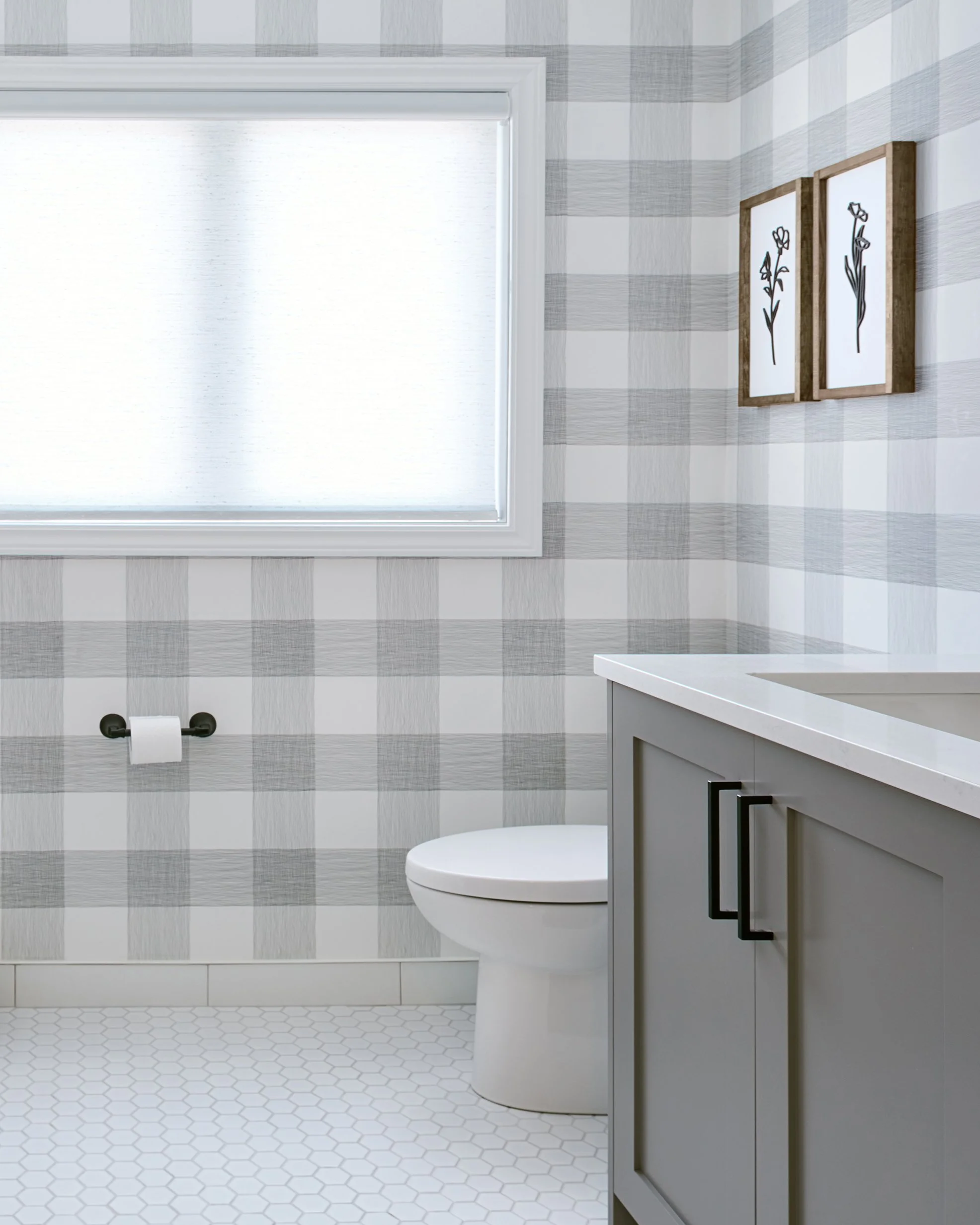 Ensuite bathroom renovation in Ottawa featuring custom grey vanity and black accessories. 