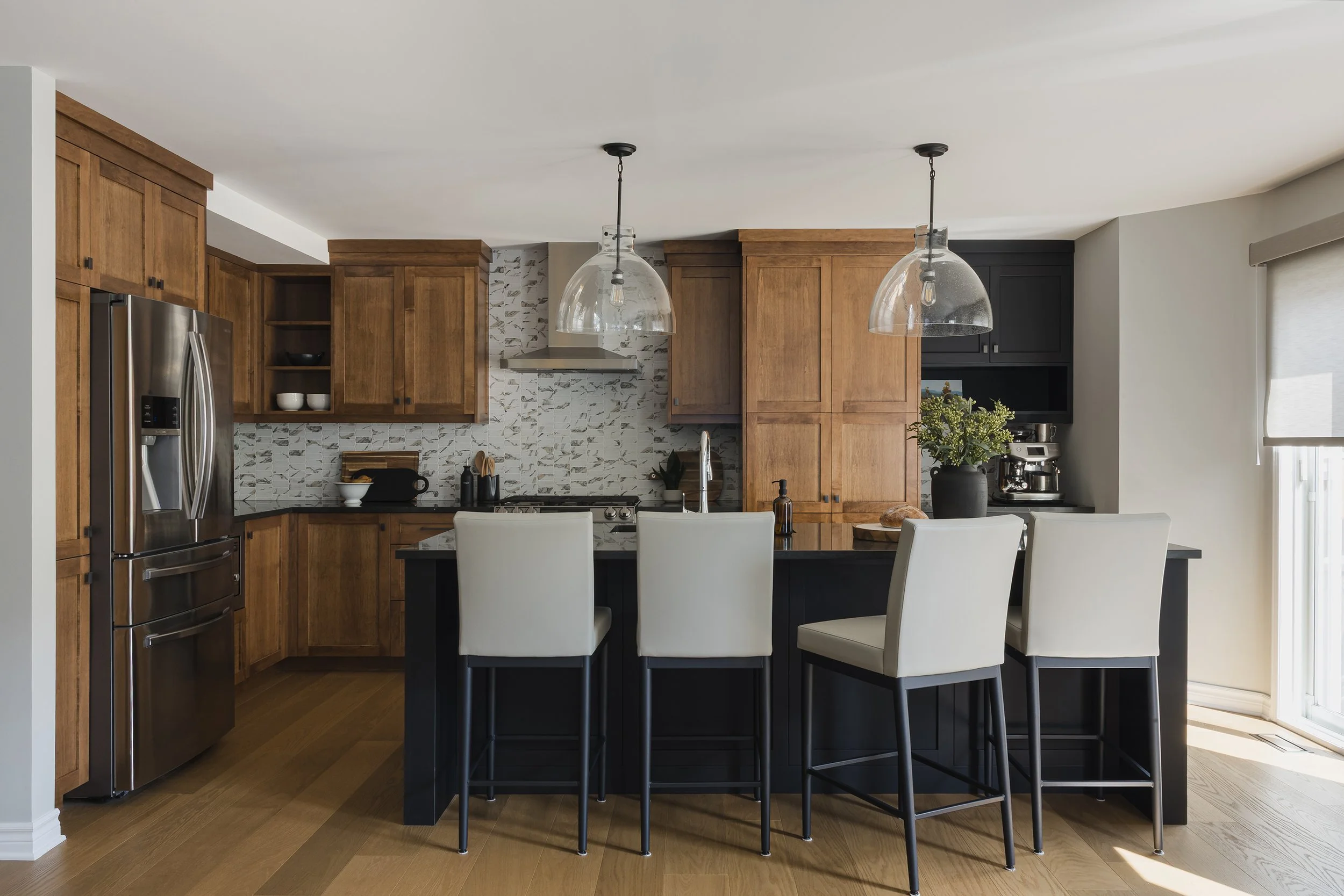 Custom kitchen renovation in Ottawa featuring warm maple cabinets and four stools at the island.