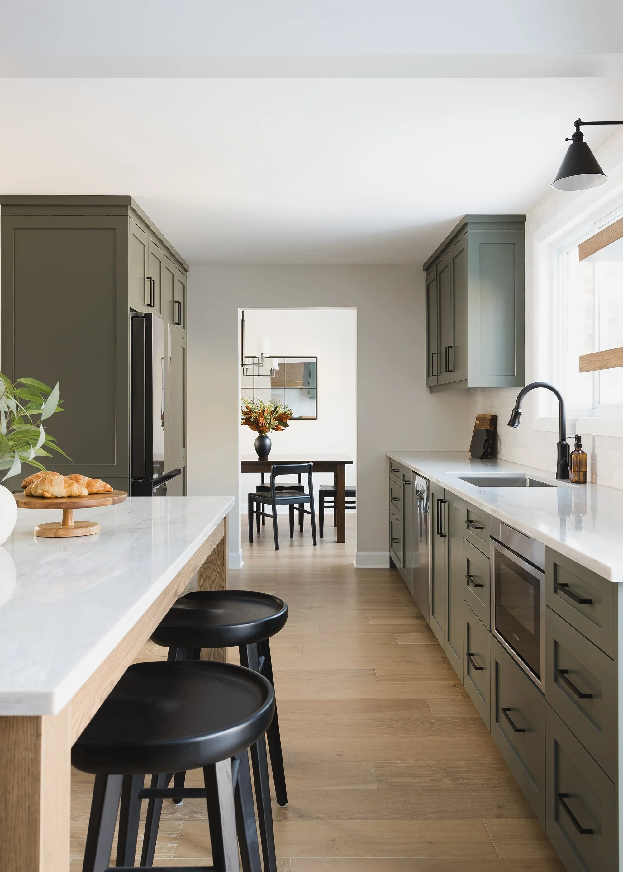 Custom kitchen renovation in Ottawa featuring green shaker cabinets and white oak. 