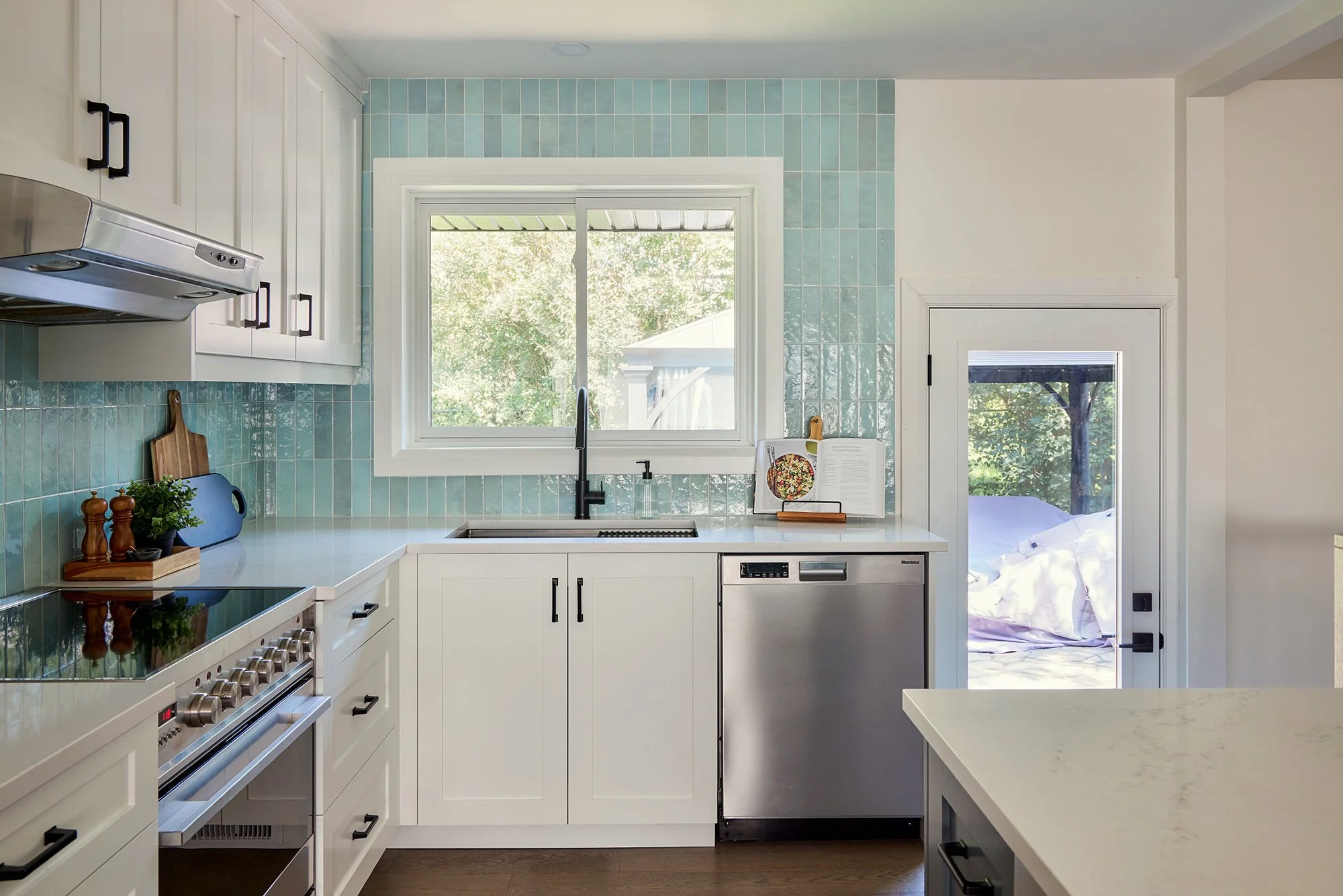 Open concept custom kitchen design for an Ottawa family home featuring white shaker cabinets mixing the styles farmhouse and mid-century. 