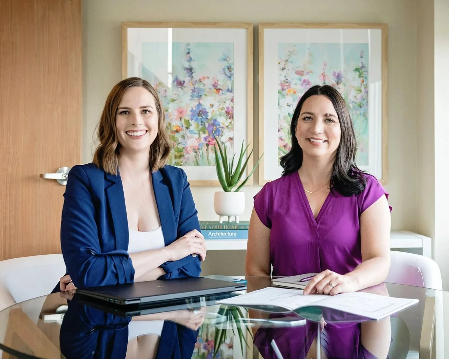 Megan Patterson and Natalie Cox, co-owners of CPI Interiors, an Ottawa interior design firm are sitting at a table.