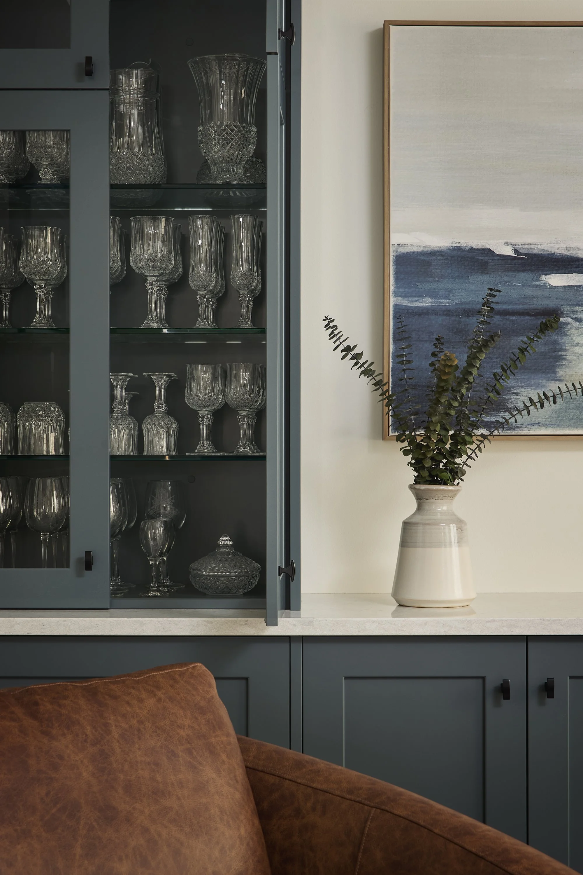 Dining room renovation in Ottawa featuring a bar made out of custom cabinetry with glass shelves for an extensive glassware collection. 