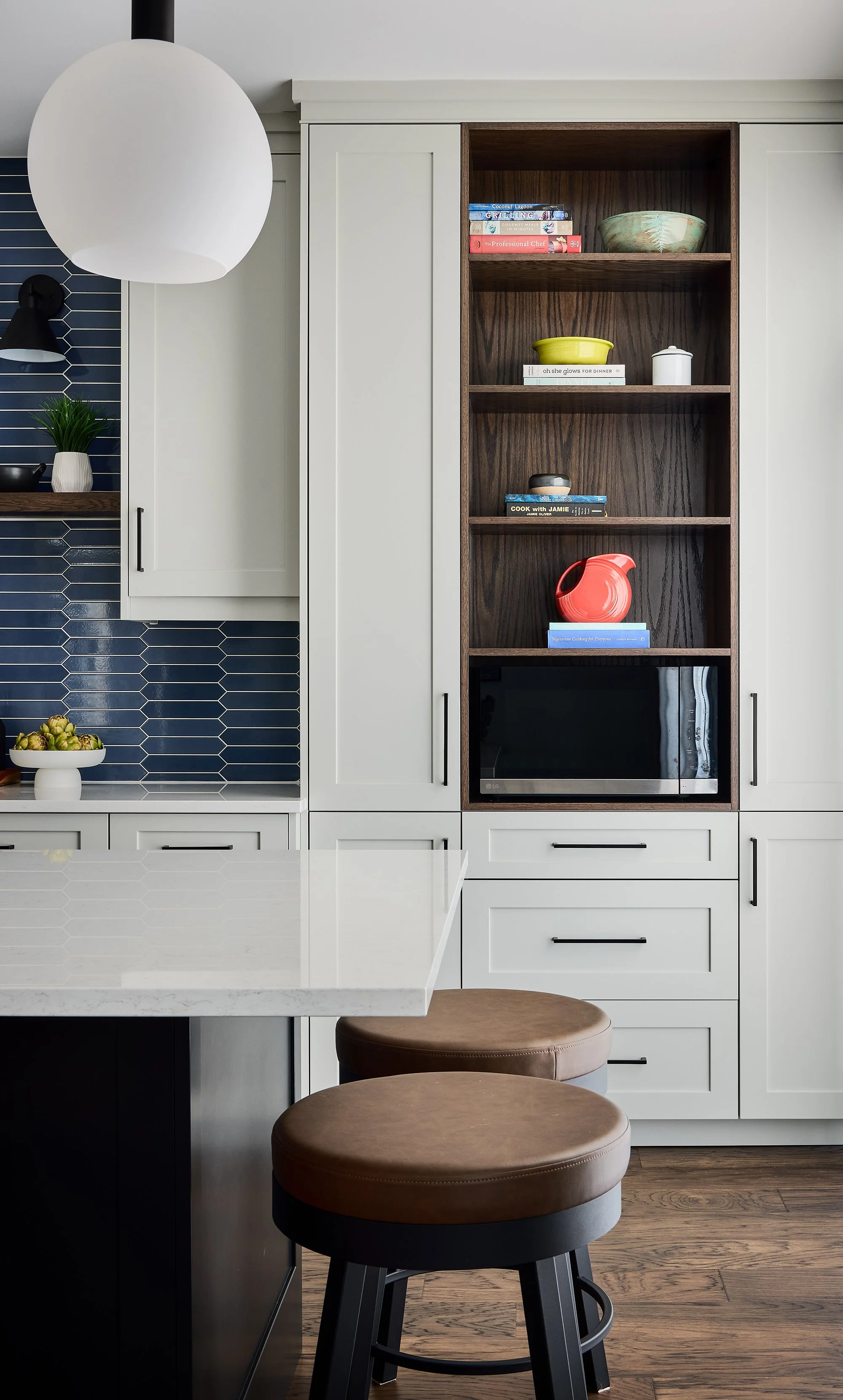 Custom kitchen renovation in Ottawa featuring light shaker cabinetry and oak open shelving. 