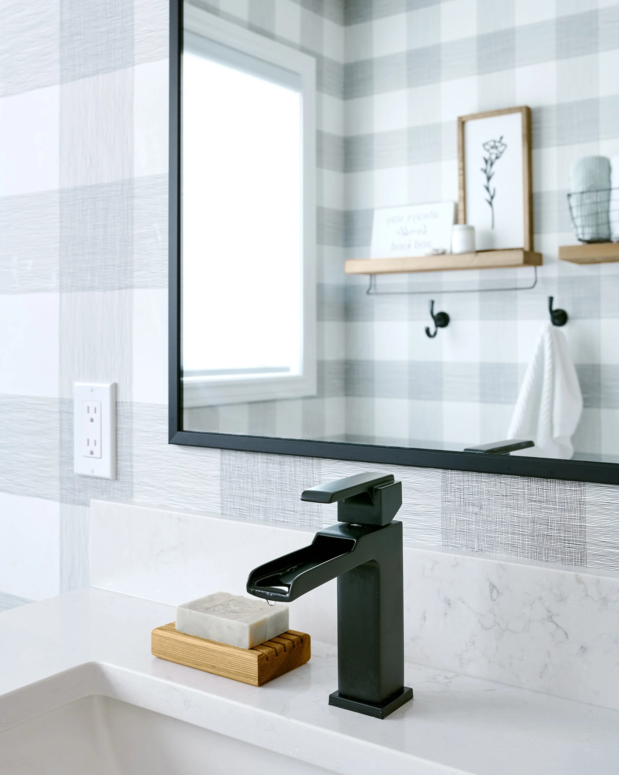 Ensuite bathroom renovation in Ottawa featuring a black waterfall faucet. 
