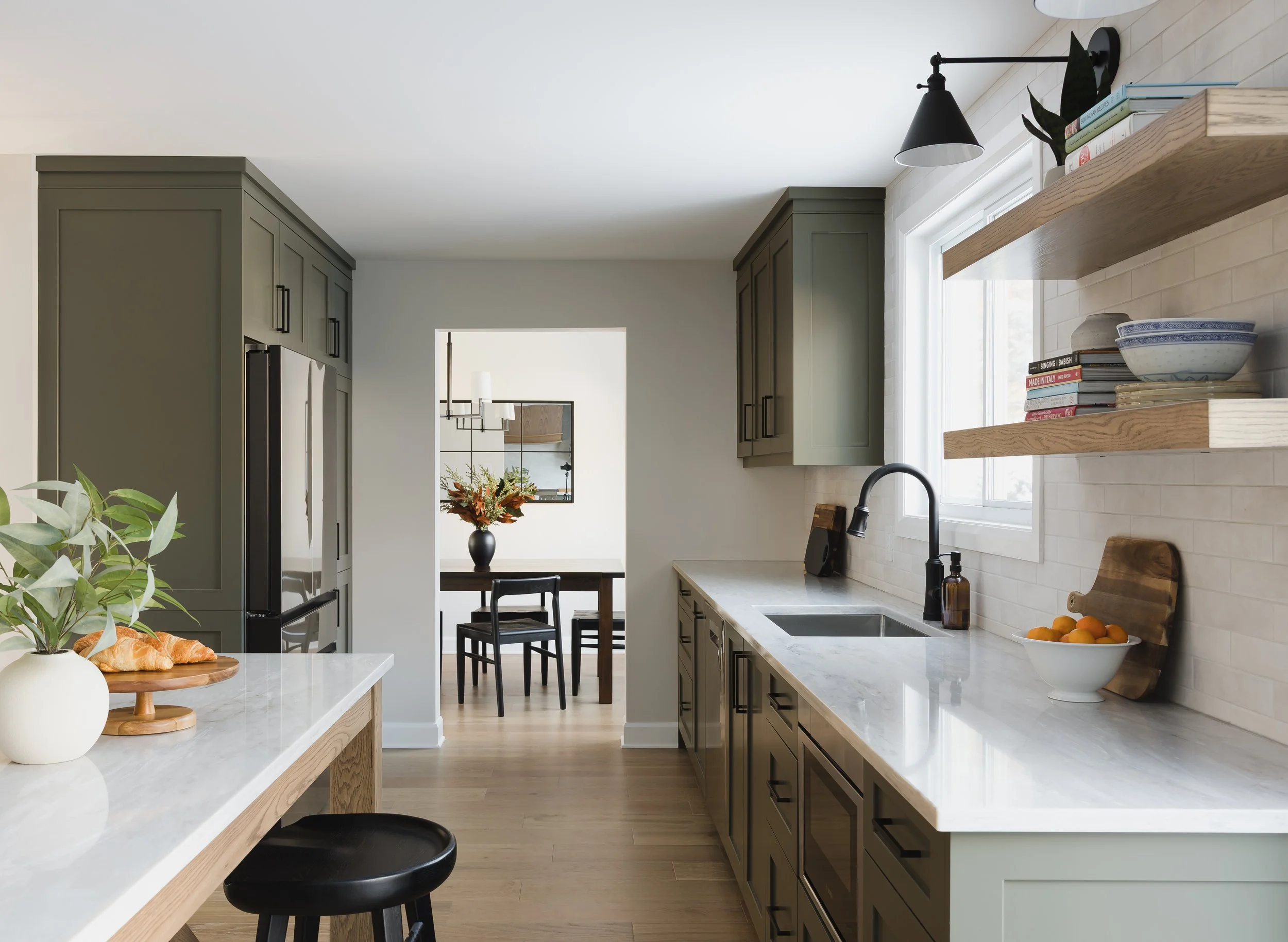 Custom kitchen renovation in Ottawa featuring green shaker cabinets and oak accents.