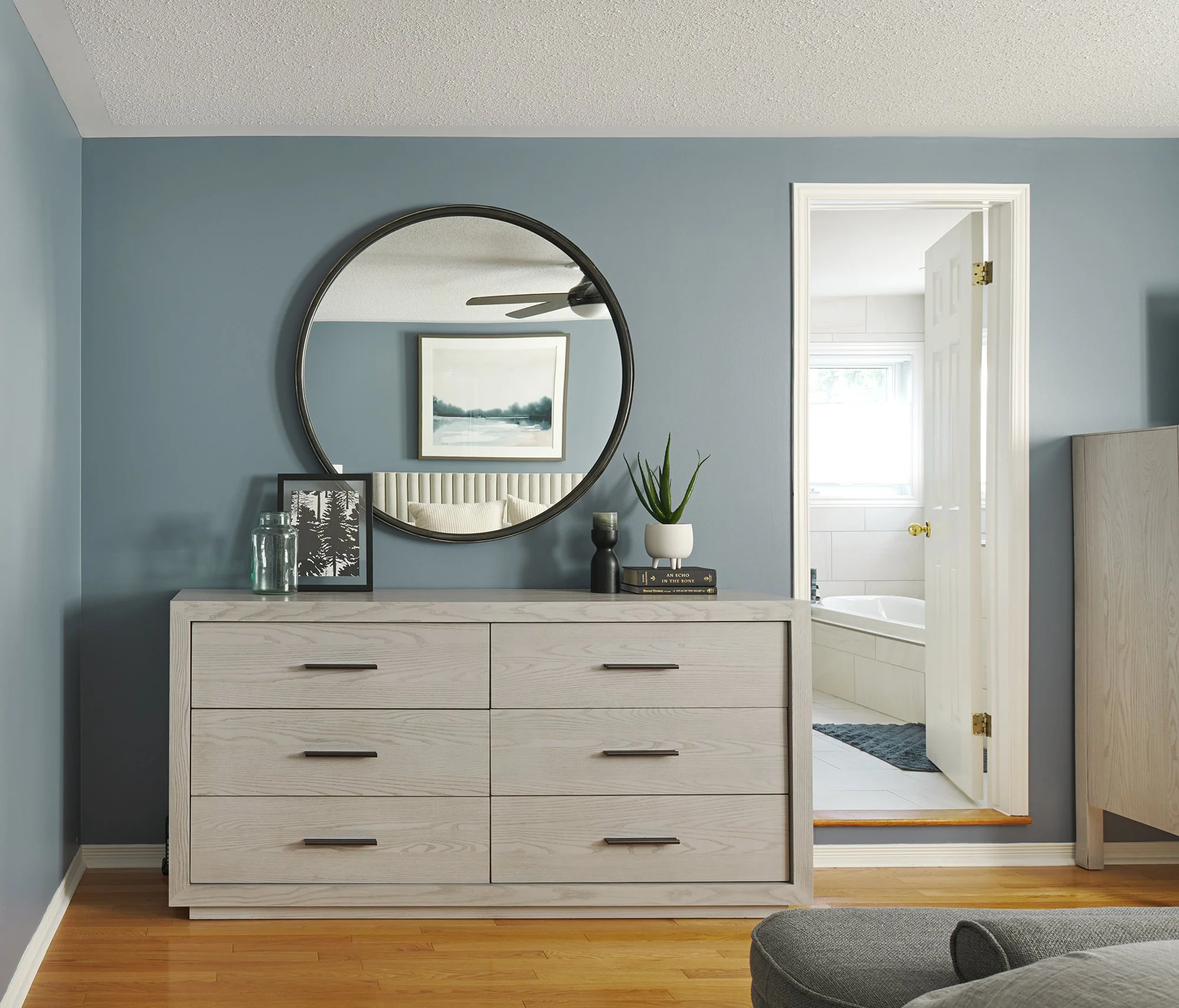 Principal bedroom design in Ottawa featuring grey modern dressers. 