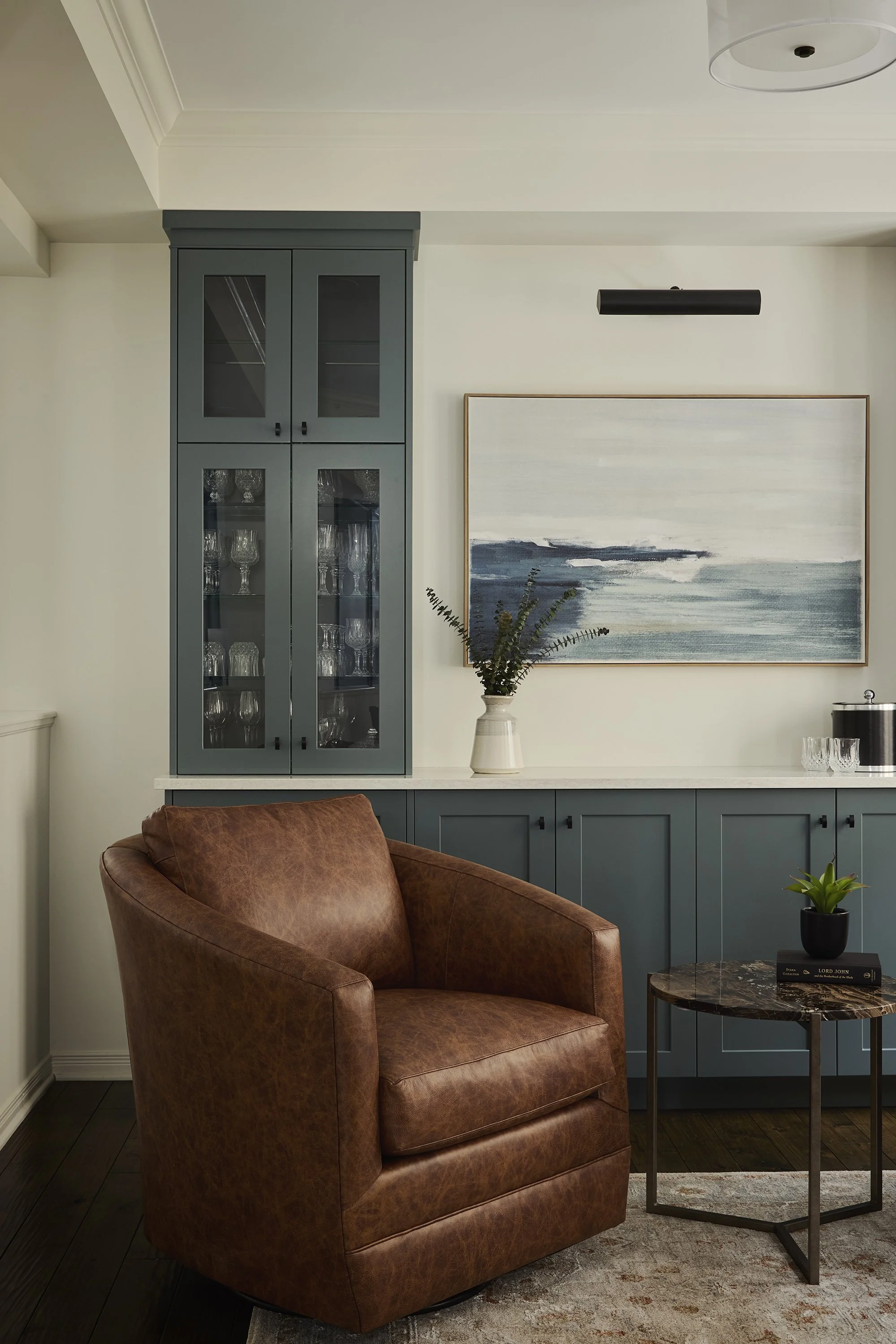 Dining room renovation in Ottawa featuring a bar made out of custom cabinetry in a beautiful teal. 