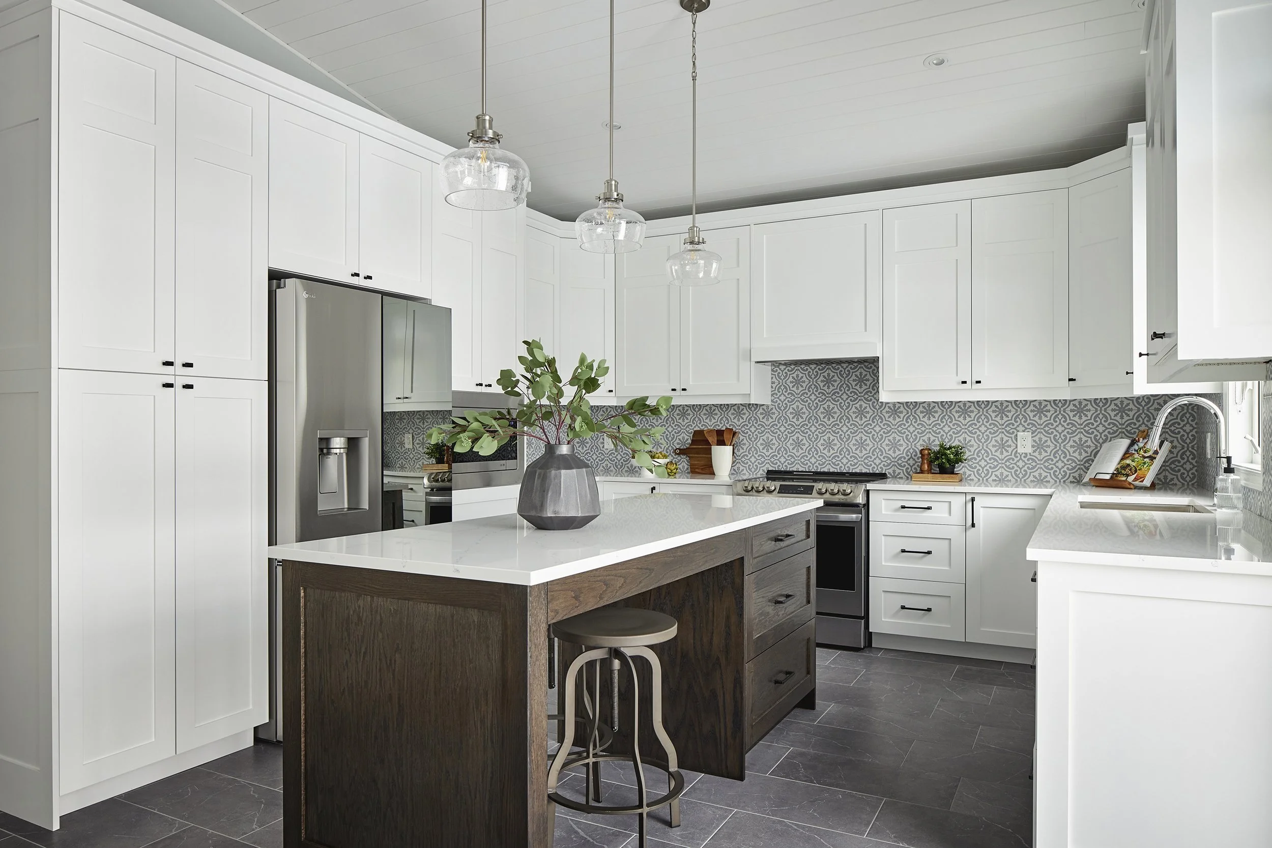 Custom kitchen renovation in Ottawa featuring white cabinets and a dark oak island. 
