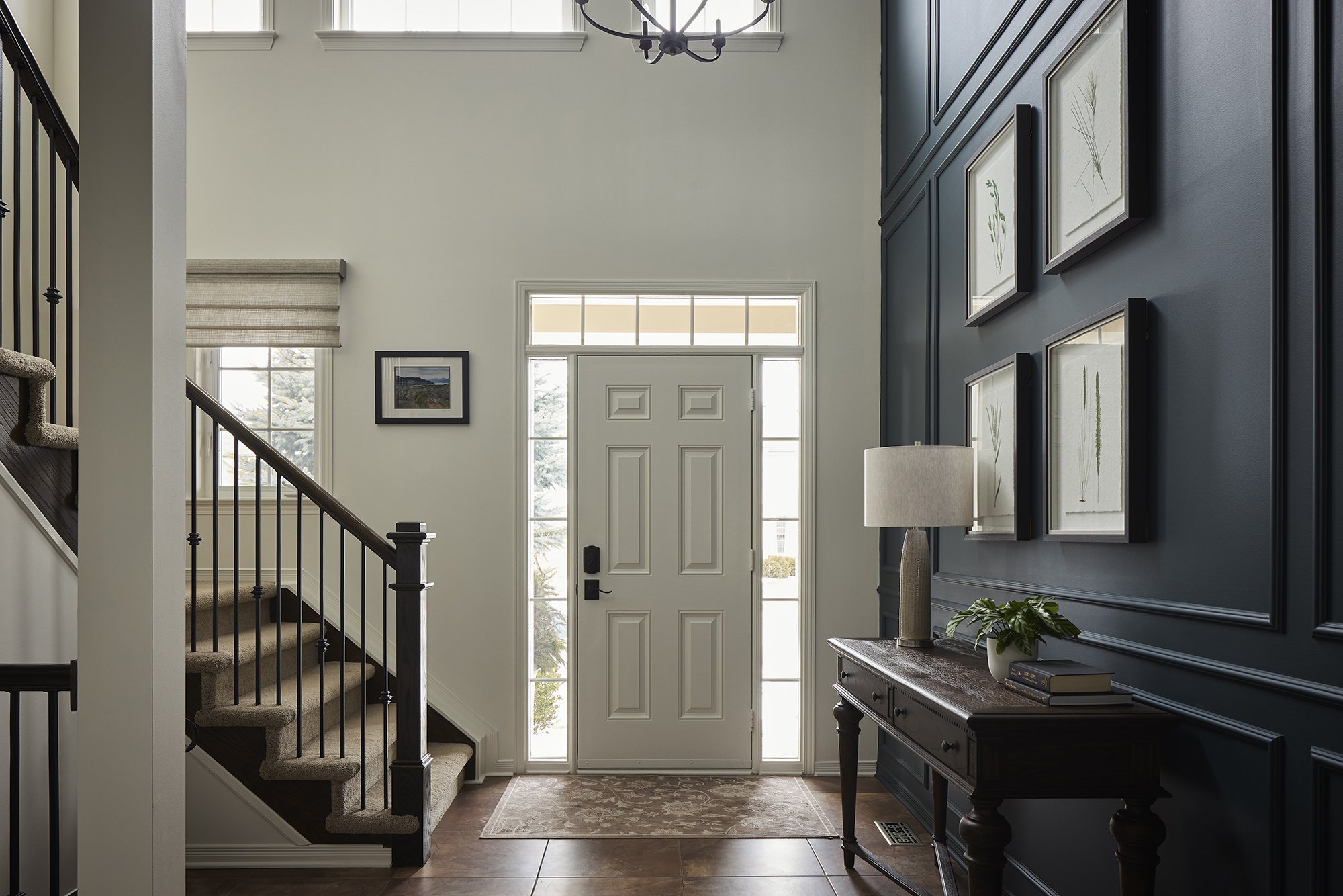 Foyer renovation in Ottawa featuring a deep rich teal accent wall and motorized roman blinds.