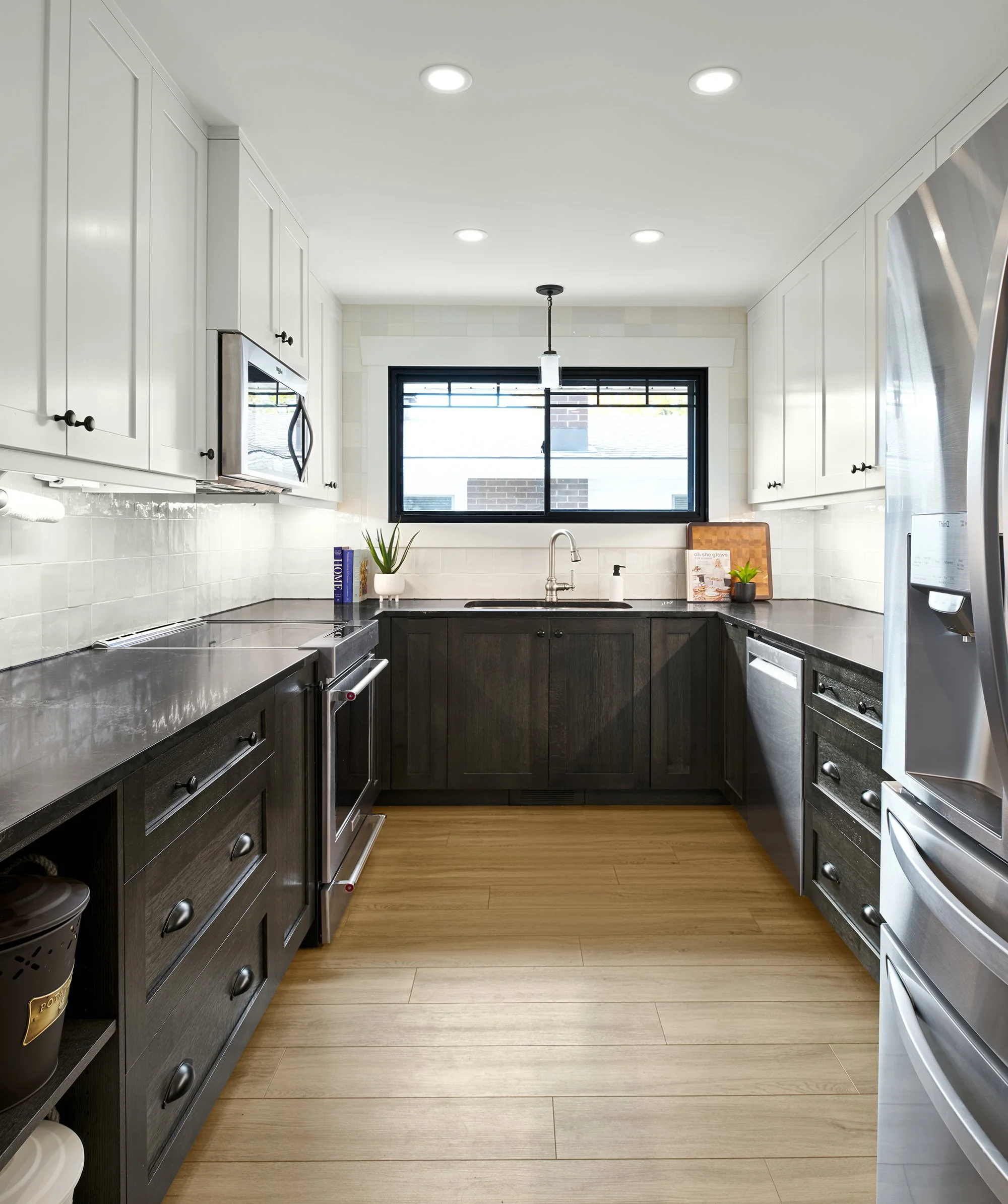 Custom kitchen renovation in Ottawa featuring white shaker upper cabinets, white oak lower cabinets and vinyl flooring. 