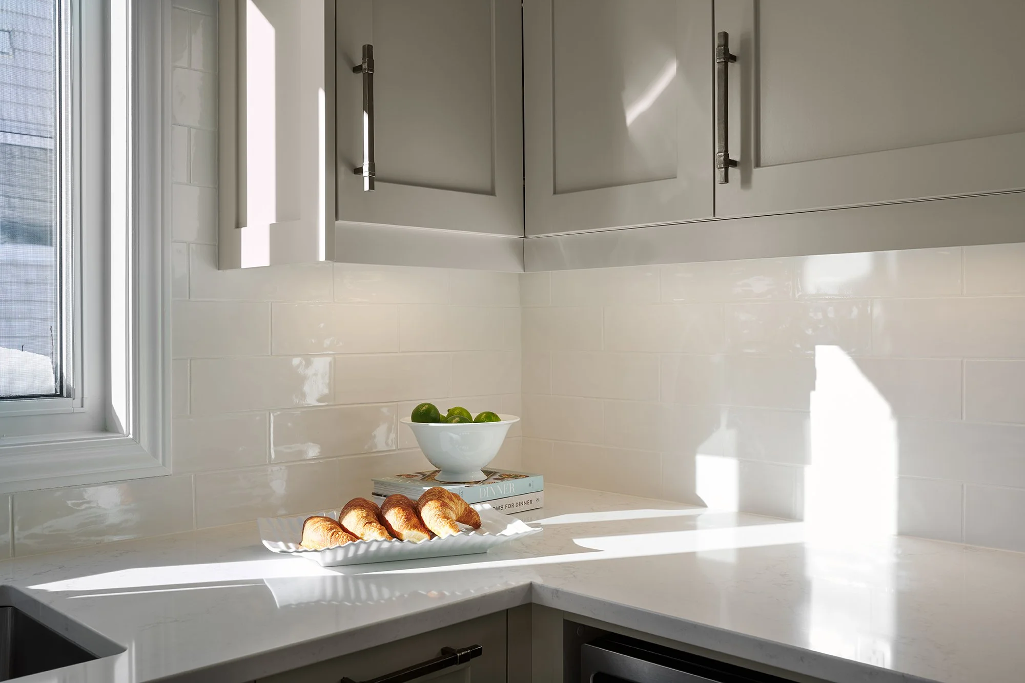 Custom kitchen renovation in Ottawa featuring warm grey shaker cabinets with black industrial hardware. 