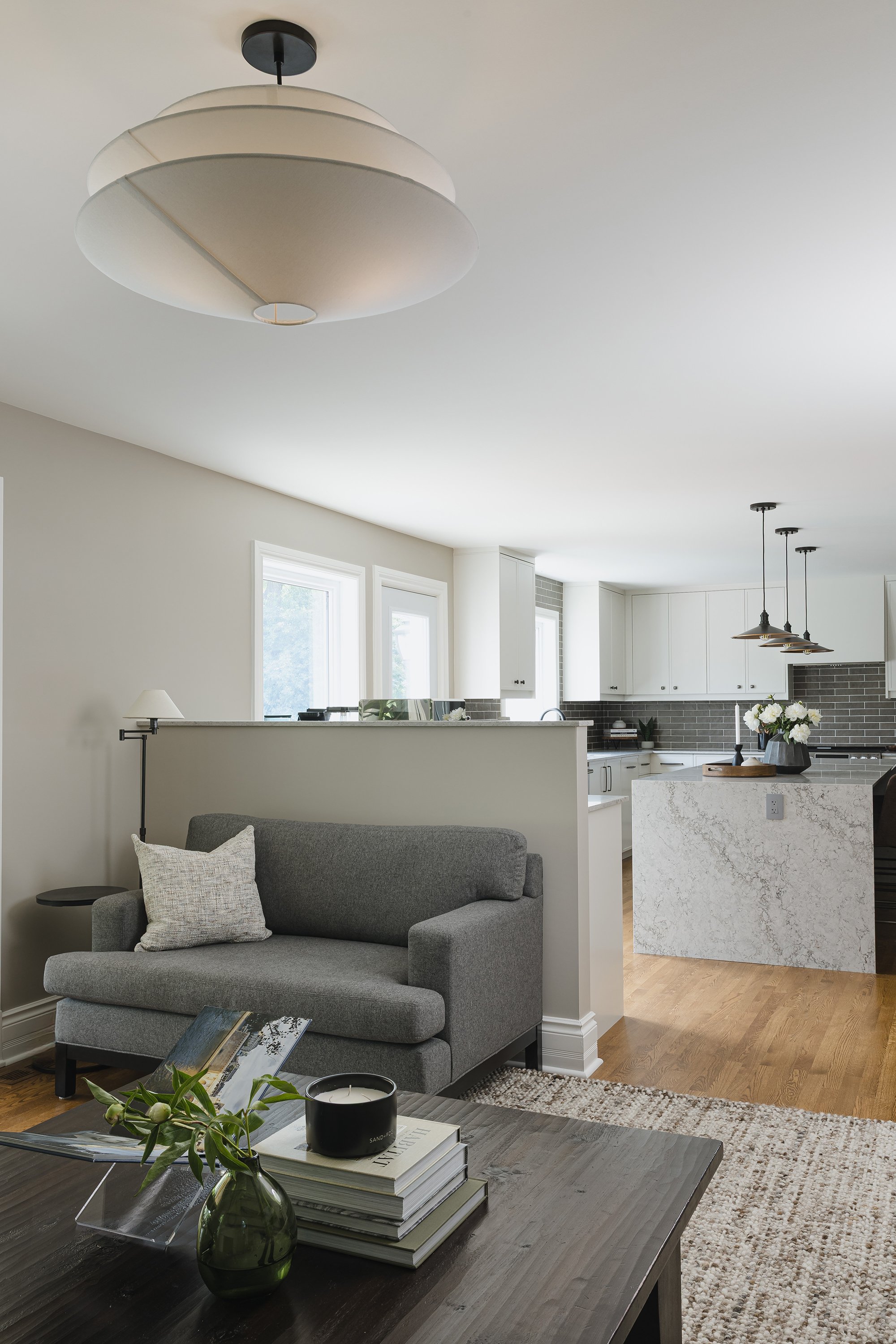 Family room design for an Ottawa family home featuring a custom oversized chair made the fit the new space. 