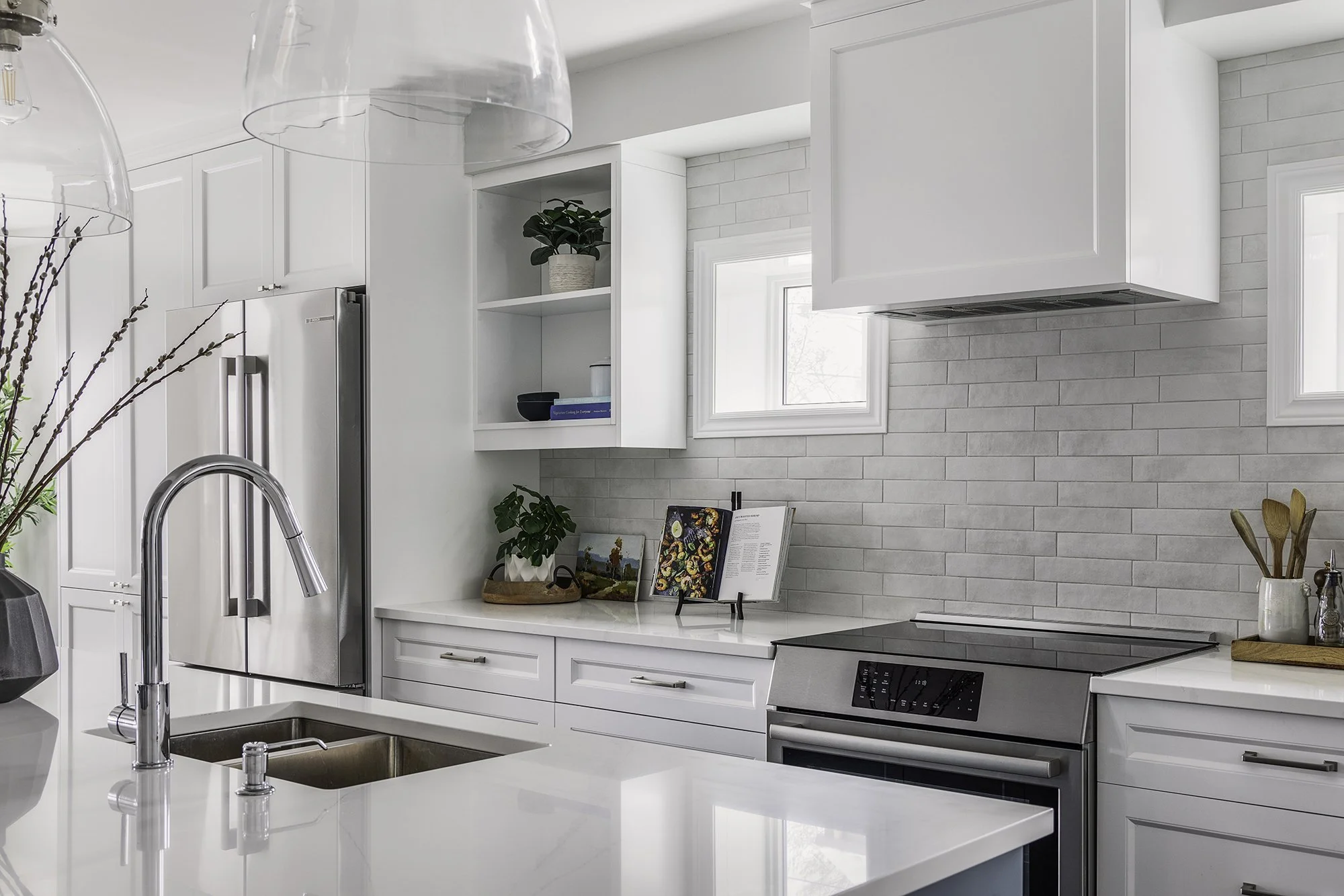 Custom kitchen renovation in Ottawa featuring open cabinets and a matte subway backsplash.  