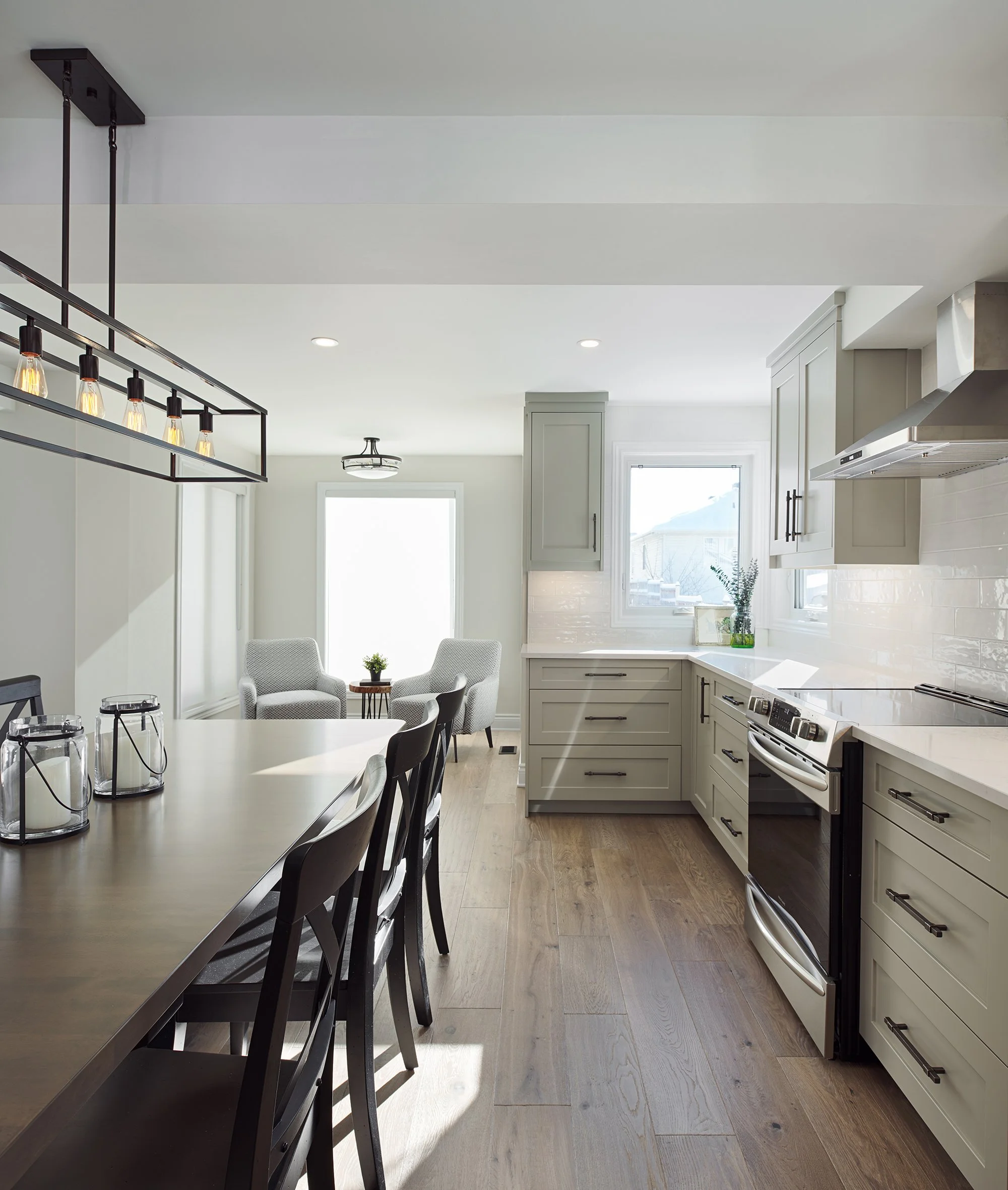 Custom kitchen renovation in Ottawa featuring warm grey shaker cabinets and engineered hardwood. 