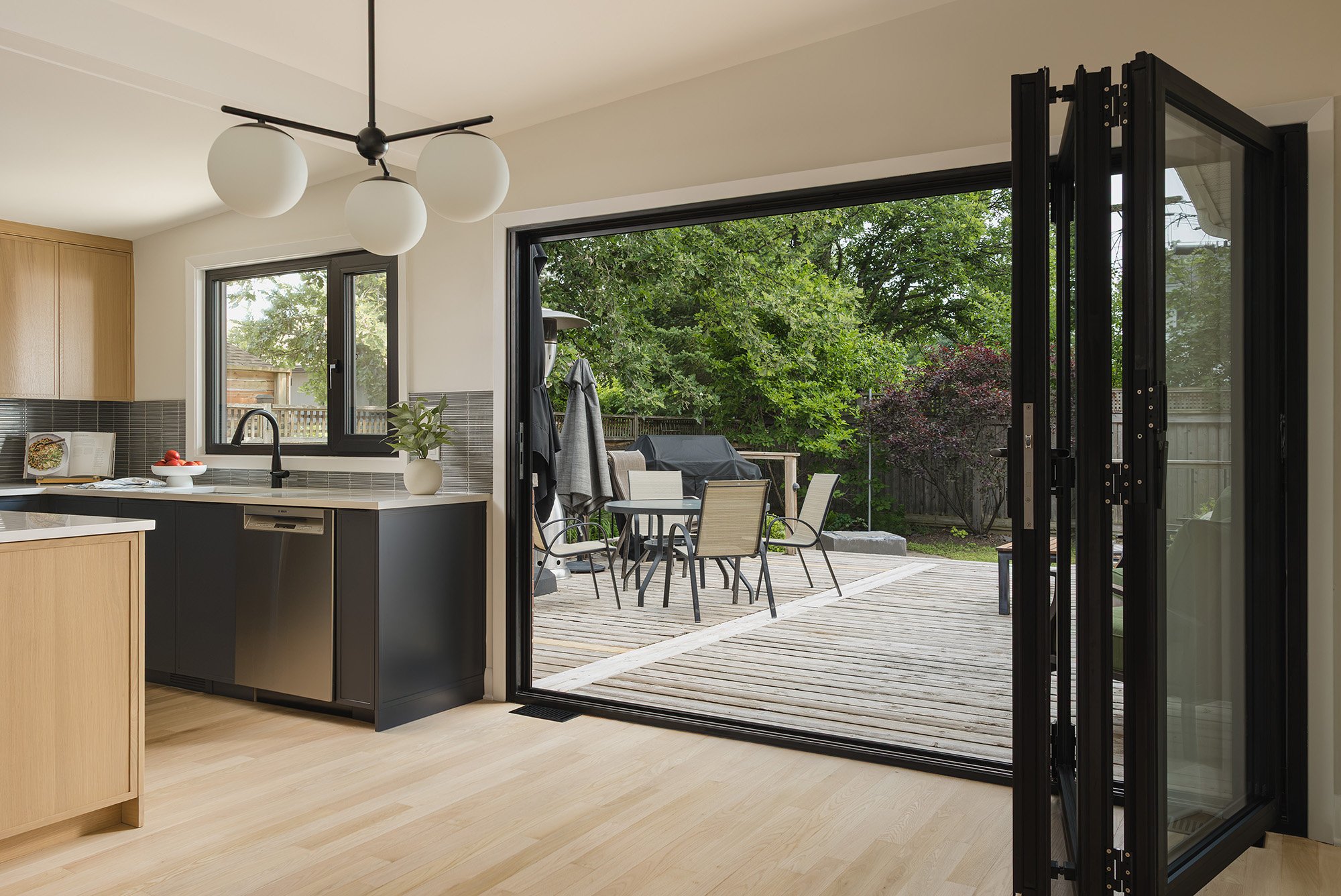 Ottawa interior design featuring a mid-century modern kitchen with accordion patio doors.