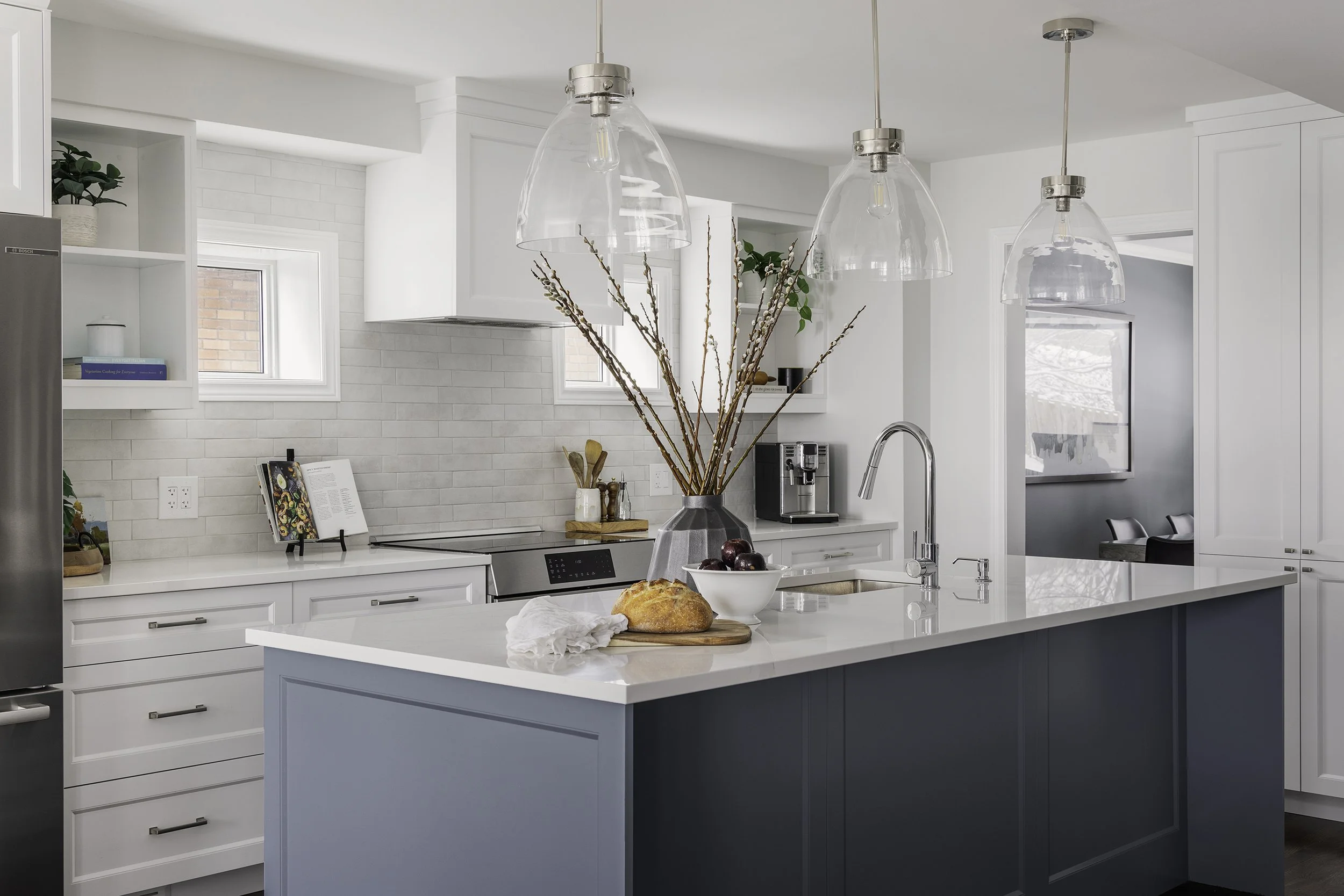 Custom kitchen renovation in Ottawa featuring white shaker cabinets and a large island for entertaining. 