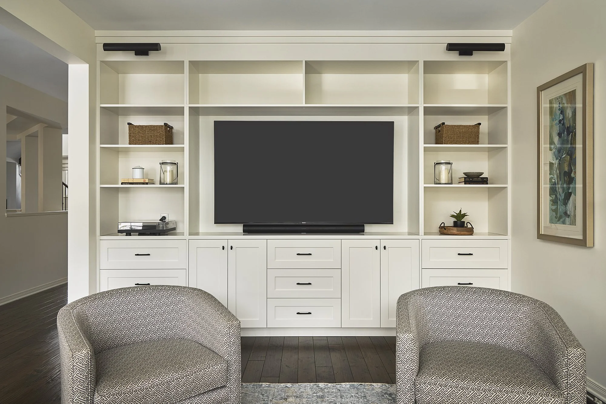Family room renovation in Ottawa featuring a creamy white custom entertainment unit. 