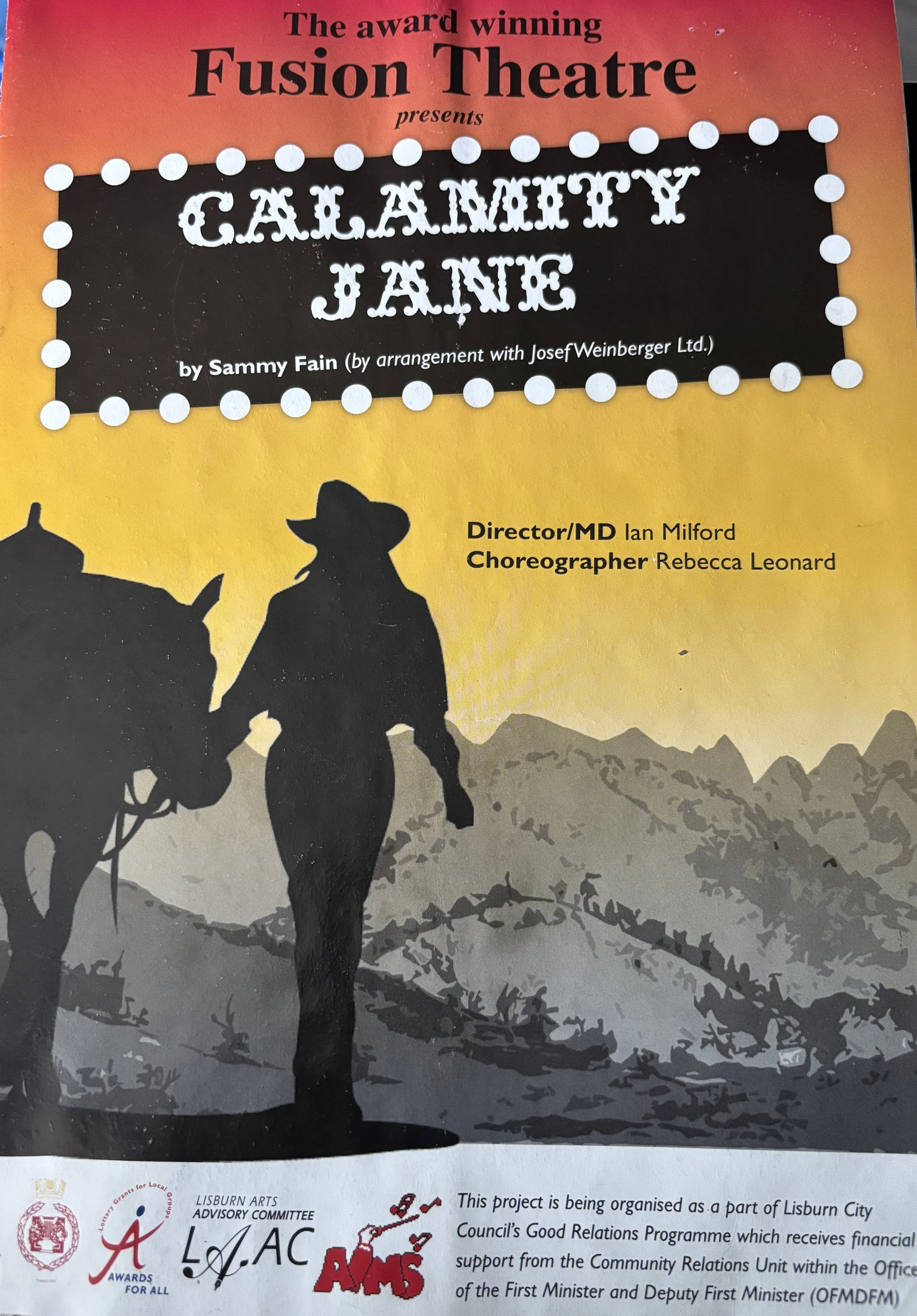 Illustration of a woman with arms raised, celebrating, with the words "Calamity Jane" in decorative letters in the sky.