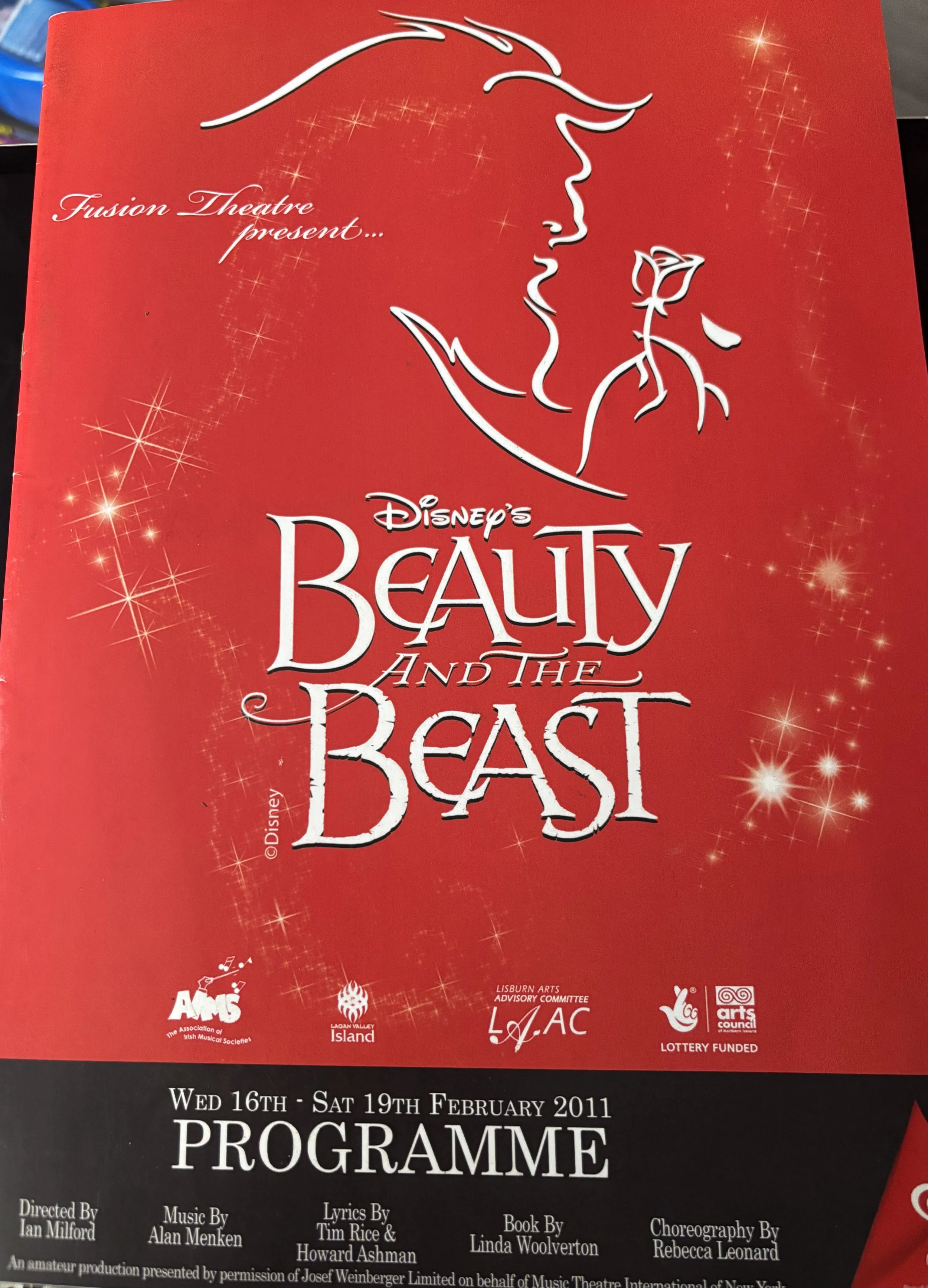 Poster for Disney's Beauty and the Beast musical featuring a stylized outline of Belle with a rose.