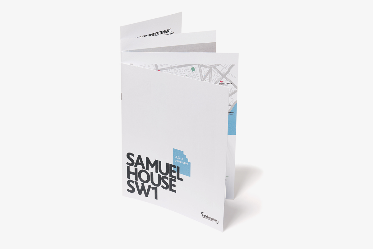 White brochure with black text reading 'SAMUEL HOUSE SW1' and a blue diagram with the words 'A fresh perspective', standing upright on a plain light gray background.