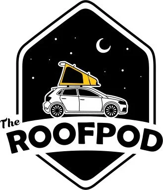 Logo of The RoofPod, featuring a white car with a yellow and black rooftop tent, under a night sky with a crescent moon and stars inside a black shield-shaped background.