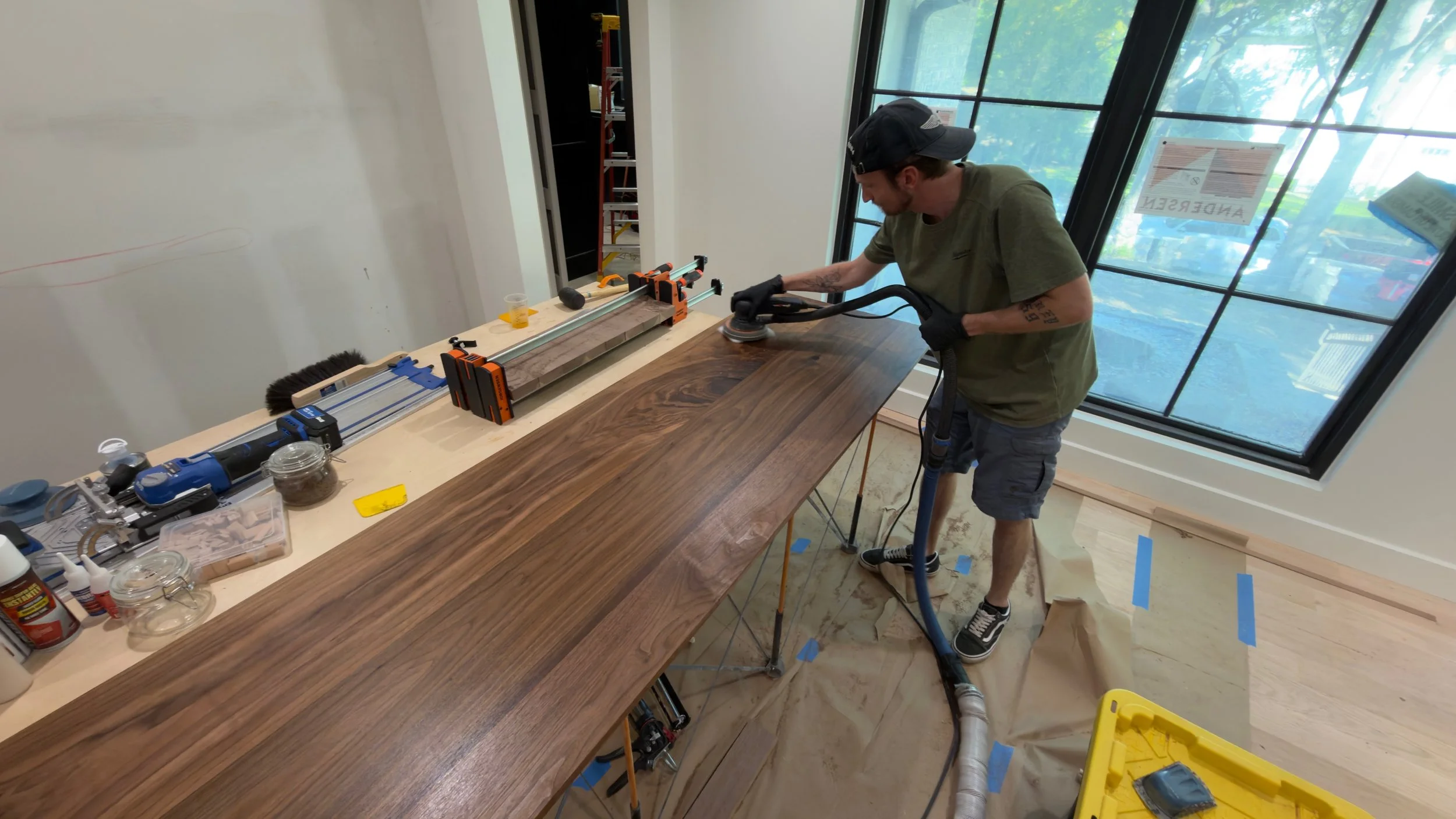 Owner of 5K Woodworks applying Rubio Monocoat to a custom solid walnut bar countertop