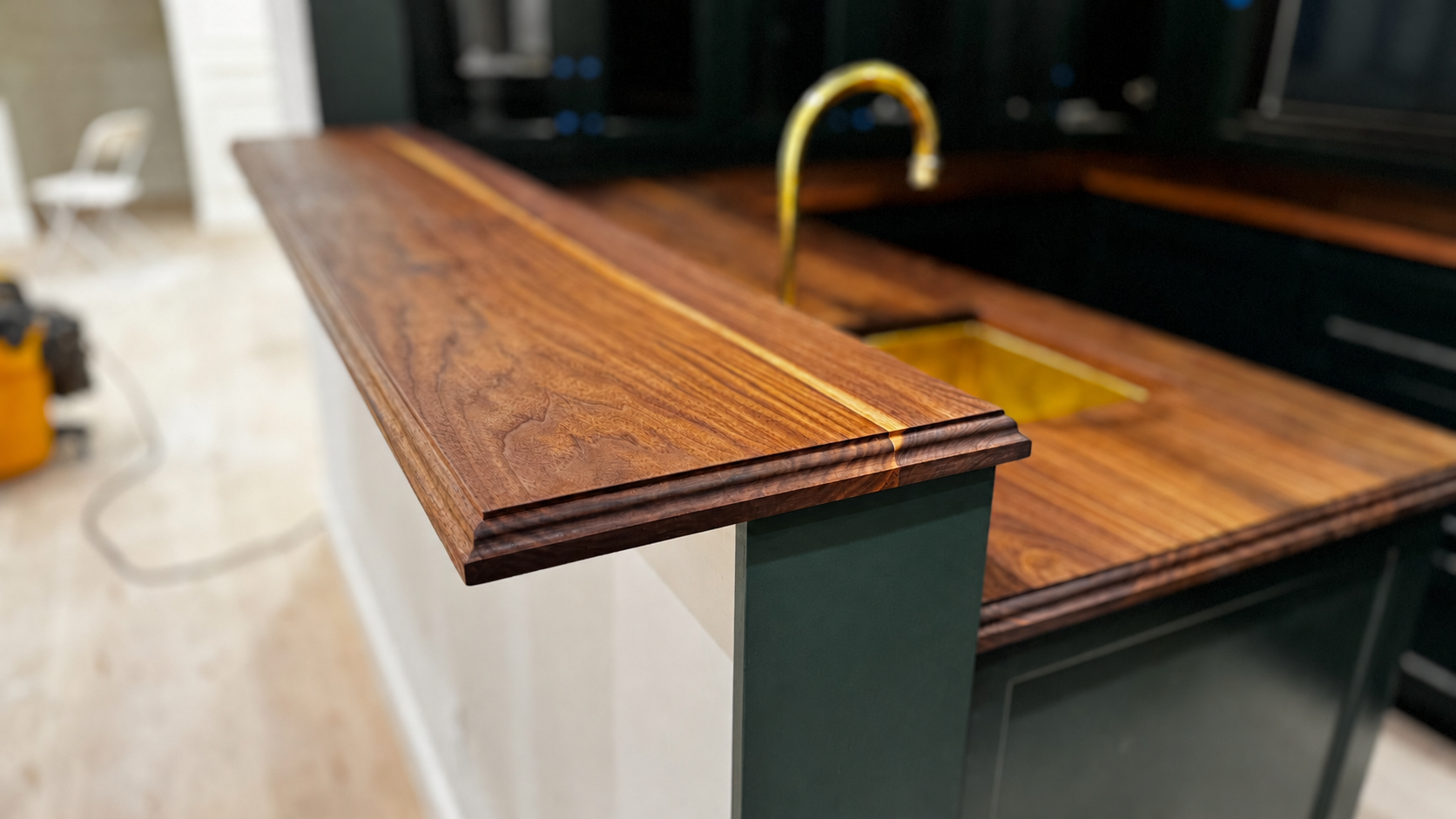 Custom walnut standing bar countertop with green cabinets in the background