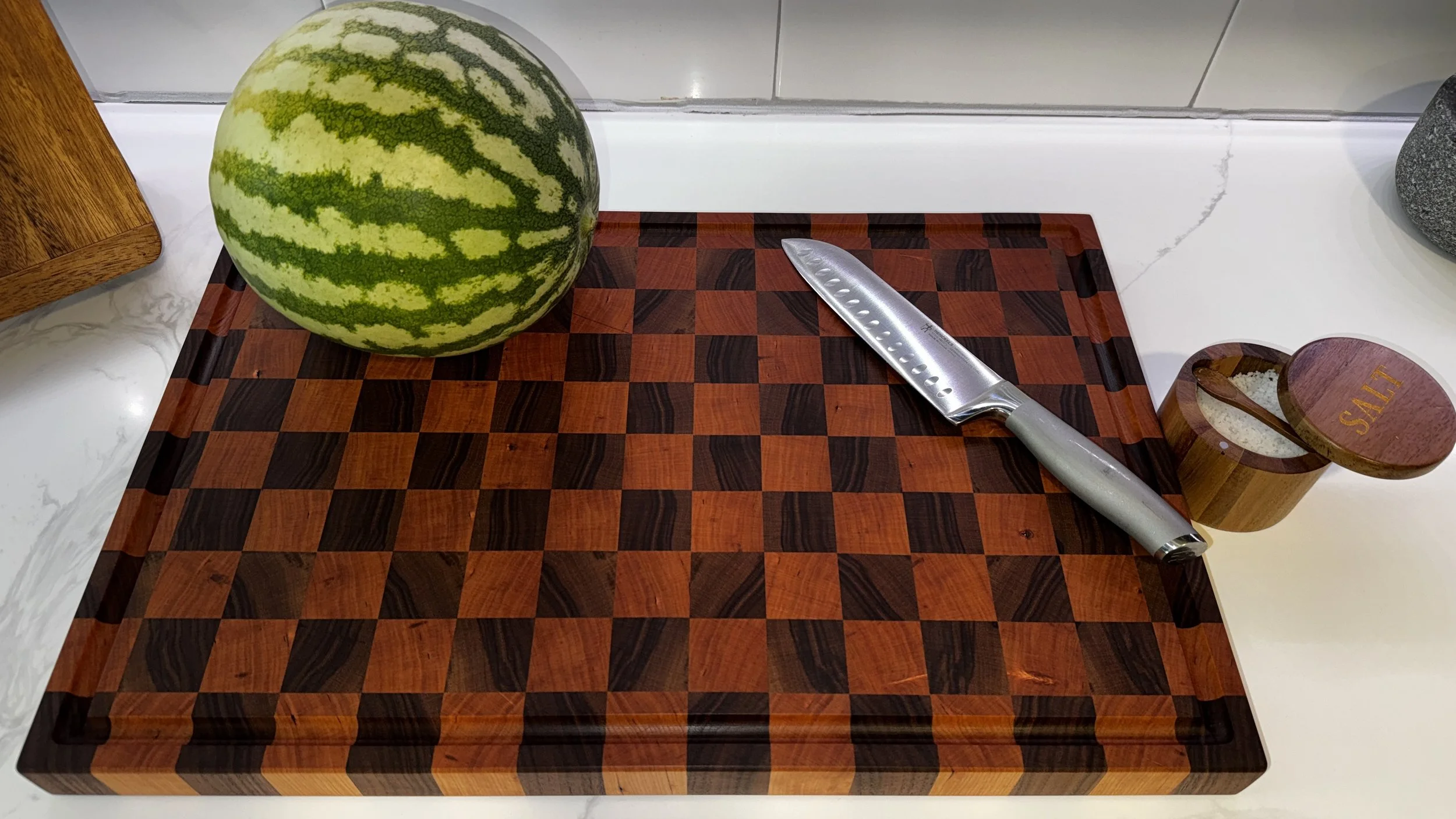Large walnut and cherry end grain cutting board with a checker board pattern. Routed in juice groove and side handles. Finished with natural, food-safe mineral oil and cutting board wax.
