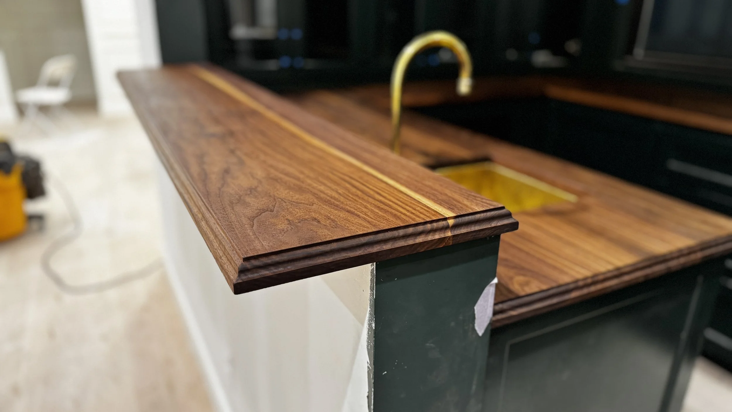 Custom solid walnut standing bar with roman ogee edge