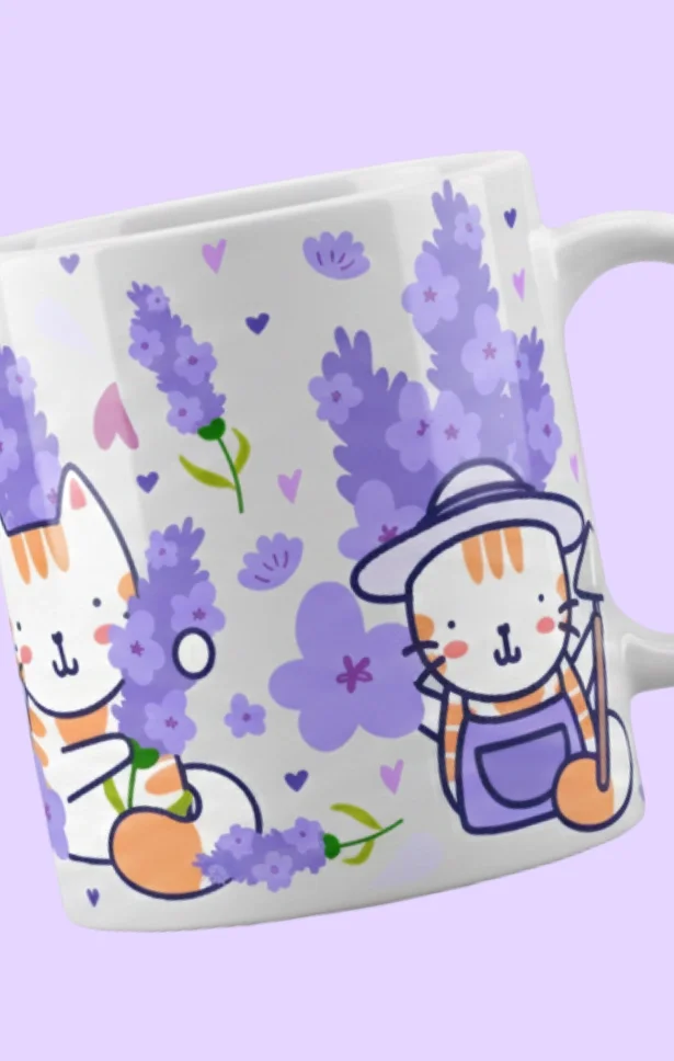 Close-up of a decorative ceramic mug with a lavender theme featuring cartoon cats, lavender flowers, and small hearts on a light purple background.