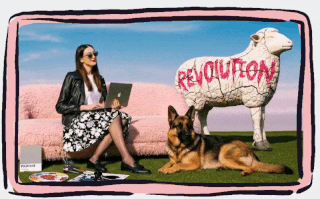 A woman sitting on a pink sofa with a laptop, a German Shepherd lying beside her, and a white sheep sculpture with the word 'REVOLUTION' written on it in red, set against a colorful background.