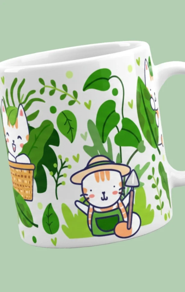 White mug with cartoon cats dressed as gardeners, surrounded by green plants and leaves, on a light green background.