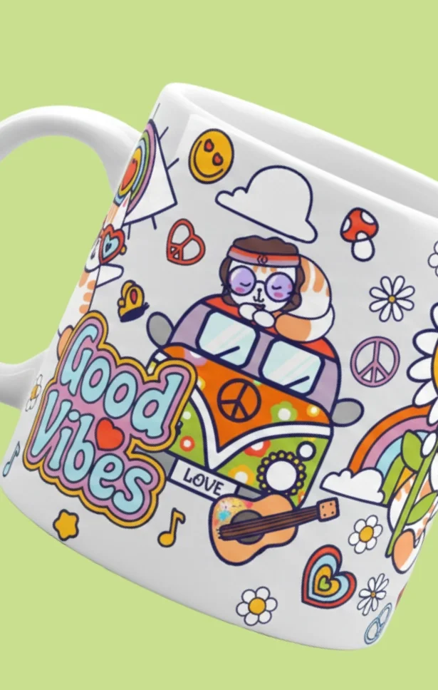 A colorful ceramic mug with illustrations of a cat driving a van with peace symbols, rainbows, flowers, hearts, a guitar, and the words "Good Vibes."
