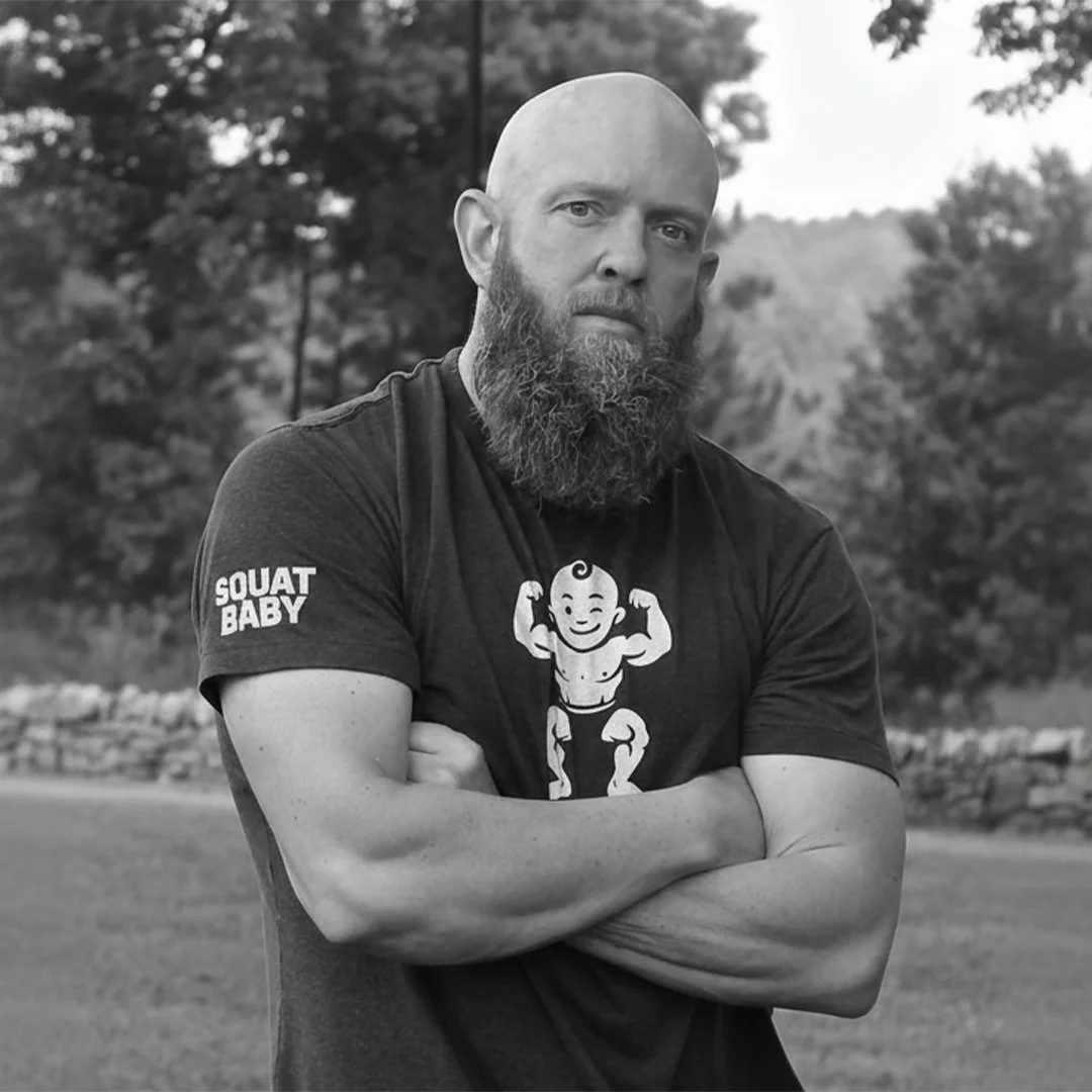 Danny, creator of Squat Baby, wearing a Squat Baby branded shirt