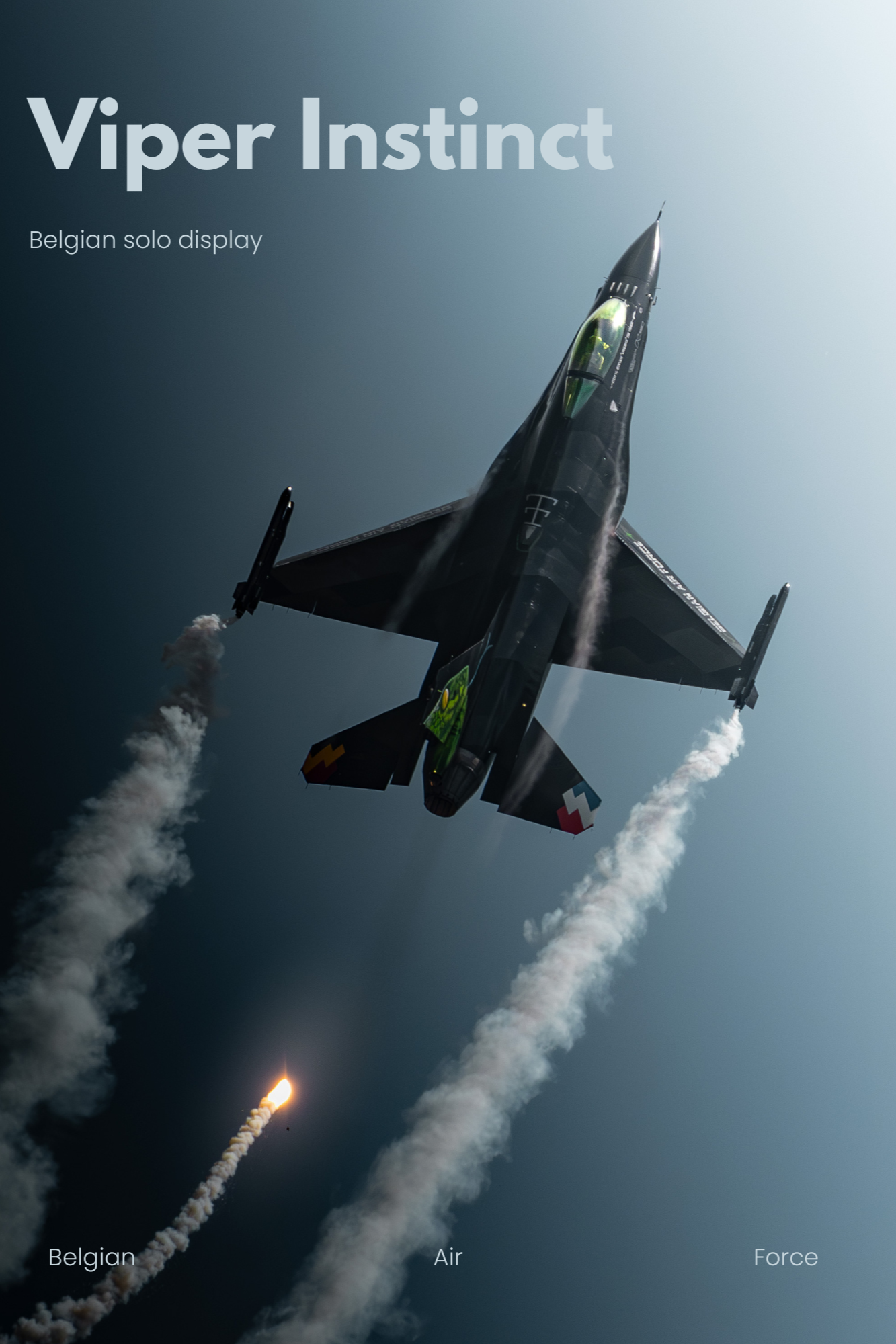 Un avion de chasse militaire F16 Belge en vol, avec des traînées de fumée blanche dans le ciel.