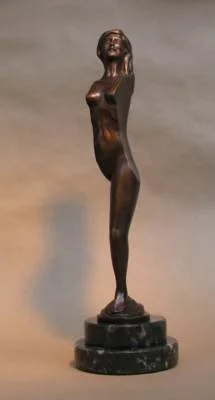 Bronze sculpture of a tall, slender woman standing on a round black base