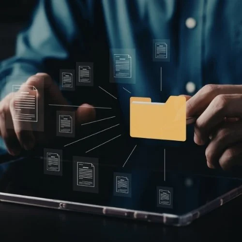 Person holding a folder with digital documents floating around, representing file management or digital storage.