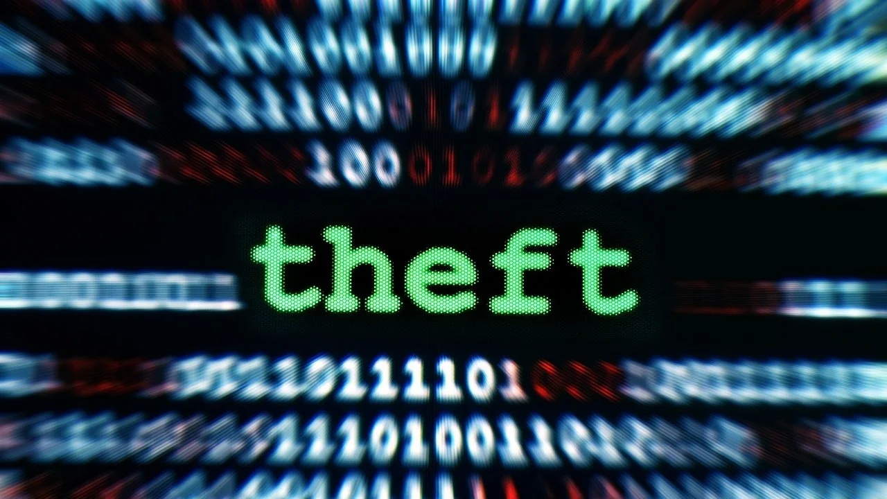 Digital display with the word 'theft' in green text, surrounded by red, blue, and white digital numbers and code.