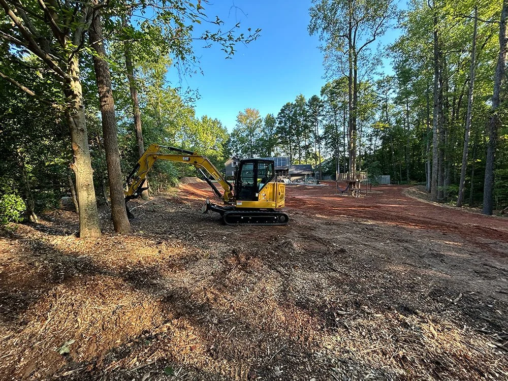Excavator clearing a wooded lot in Cabarrus County