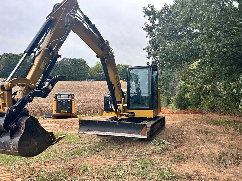 Mini excavator working on a rural job site