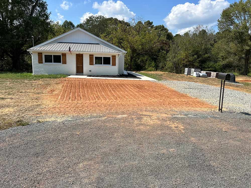 New gravel driveway leading to a home