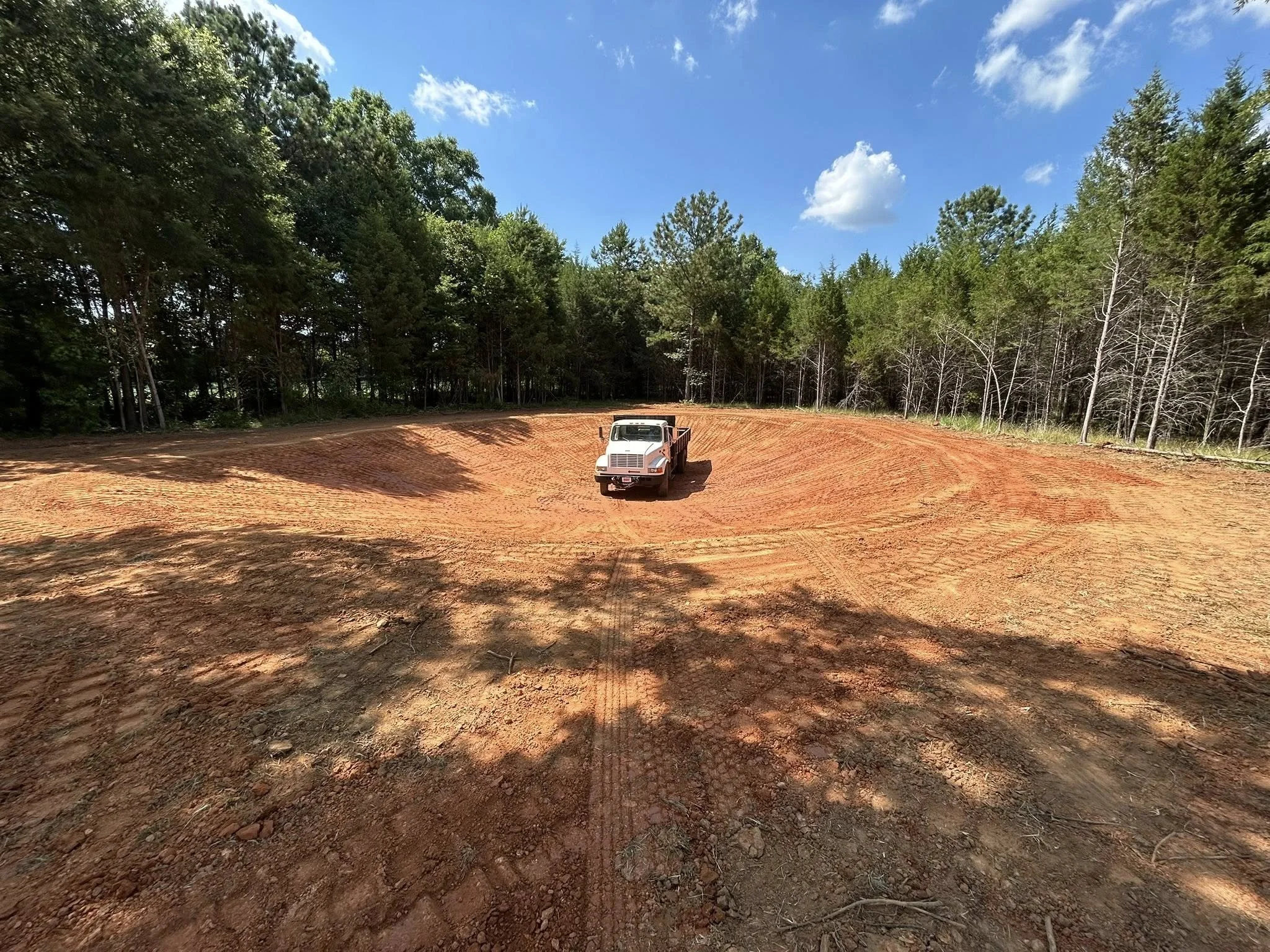 cleared lot with work truck parked in center