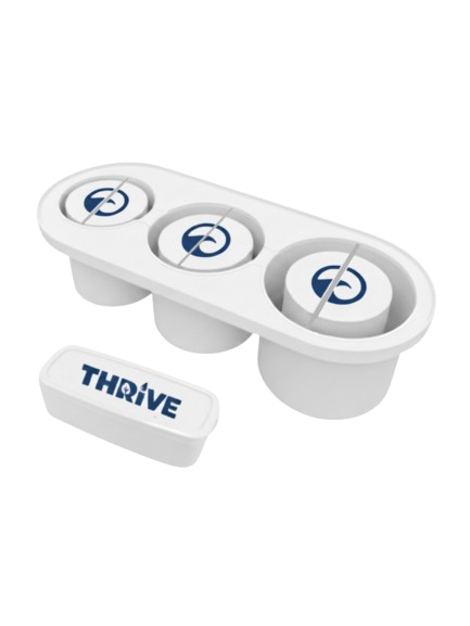 A white circular device with four compartments, each containing a blue target symbol, and a small white container labeled "THRIVE" placed beside it.