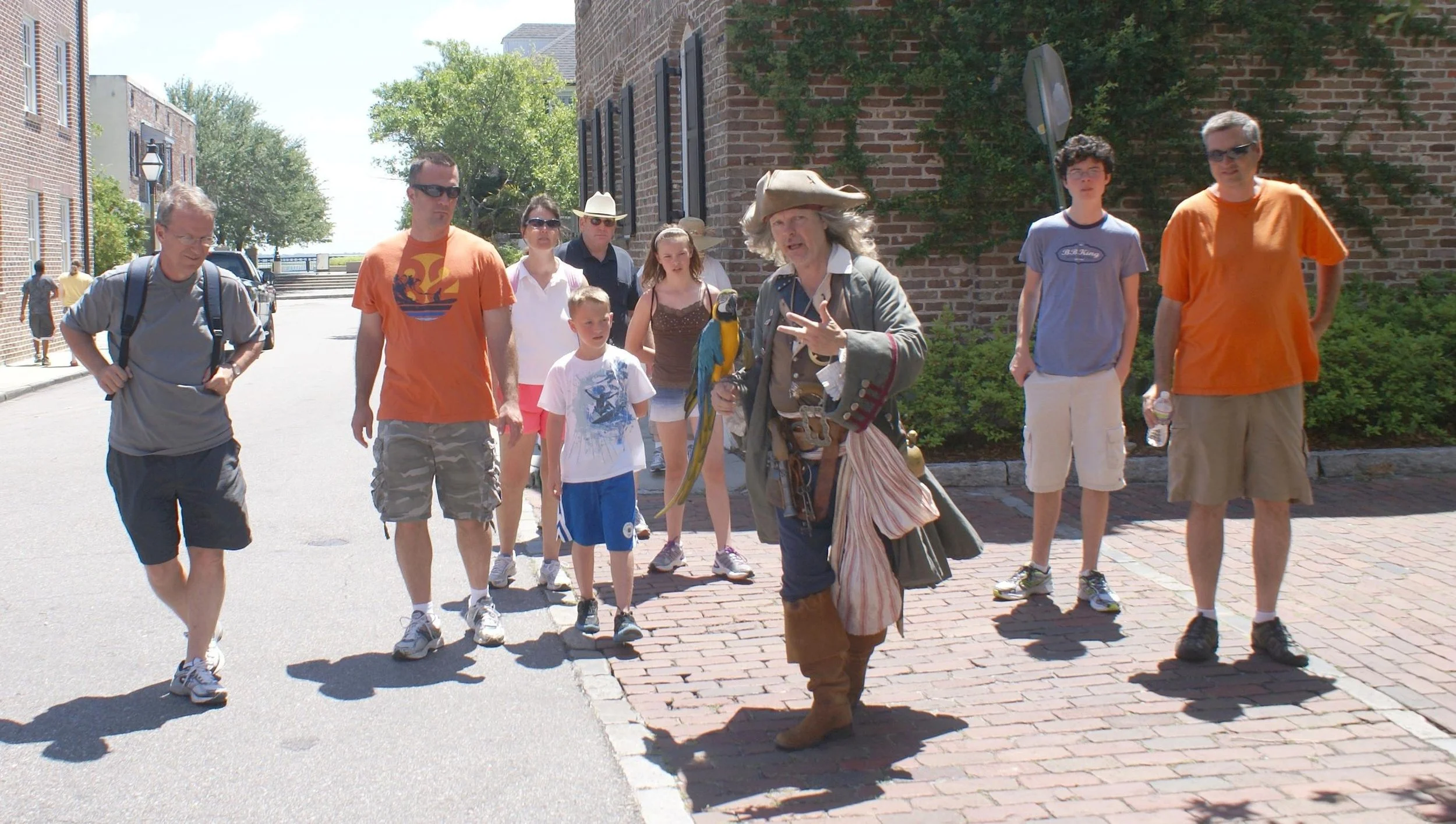 Man dressed as pirate talking to a tour group about pirate history in Charleston