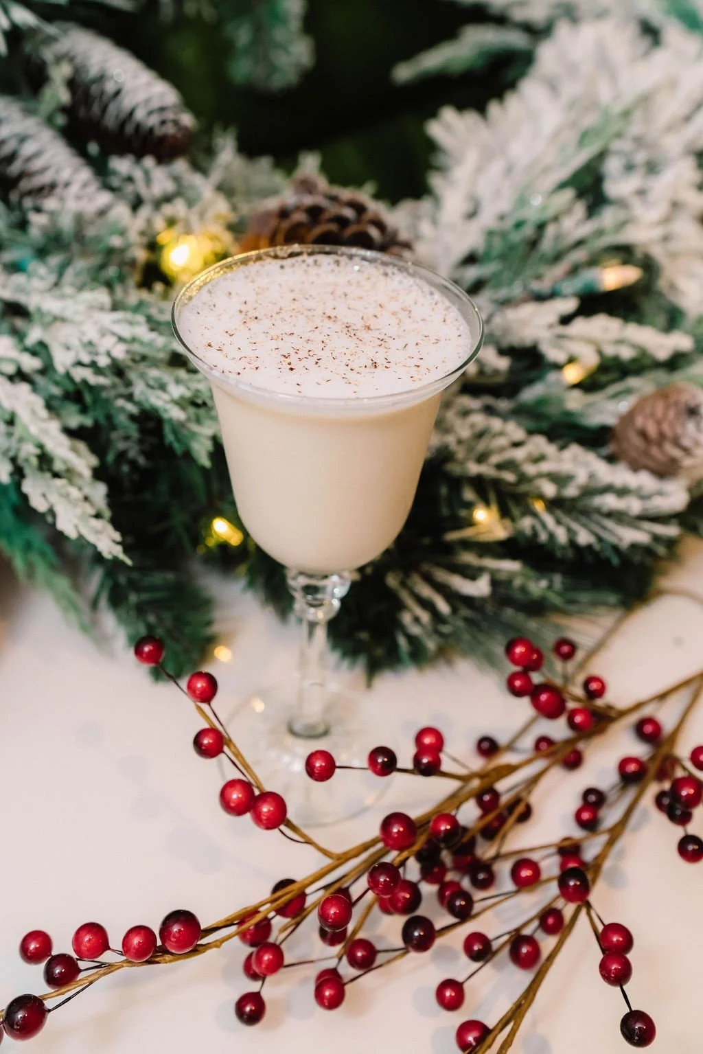 Christmas Cocktail near a festive wreath. Things to do in Charleston at Christmas.