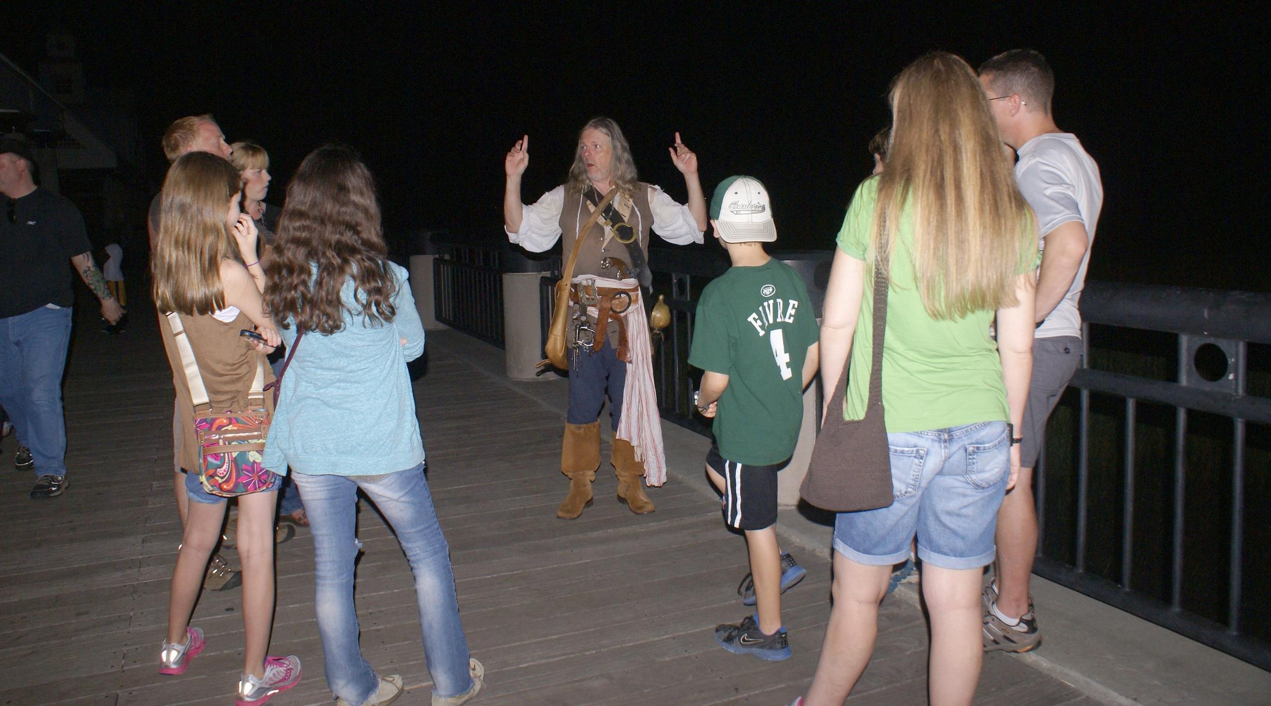 Man in Pirate costume telling ghost stories to a tour group in Charleston.