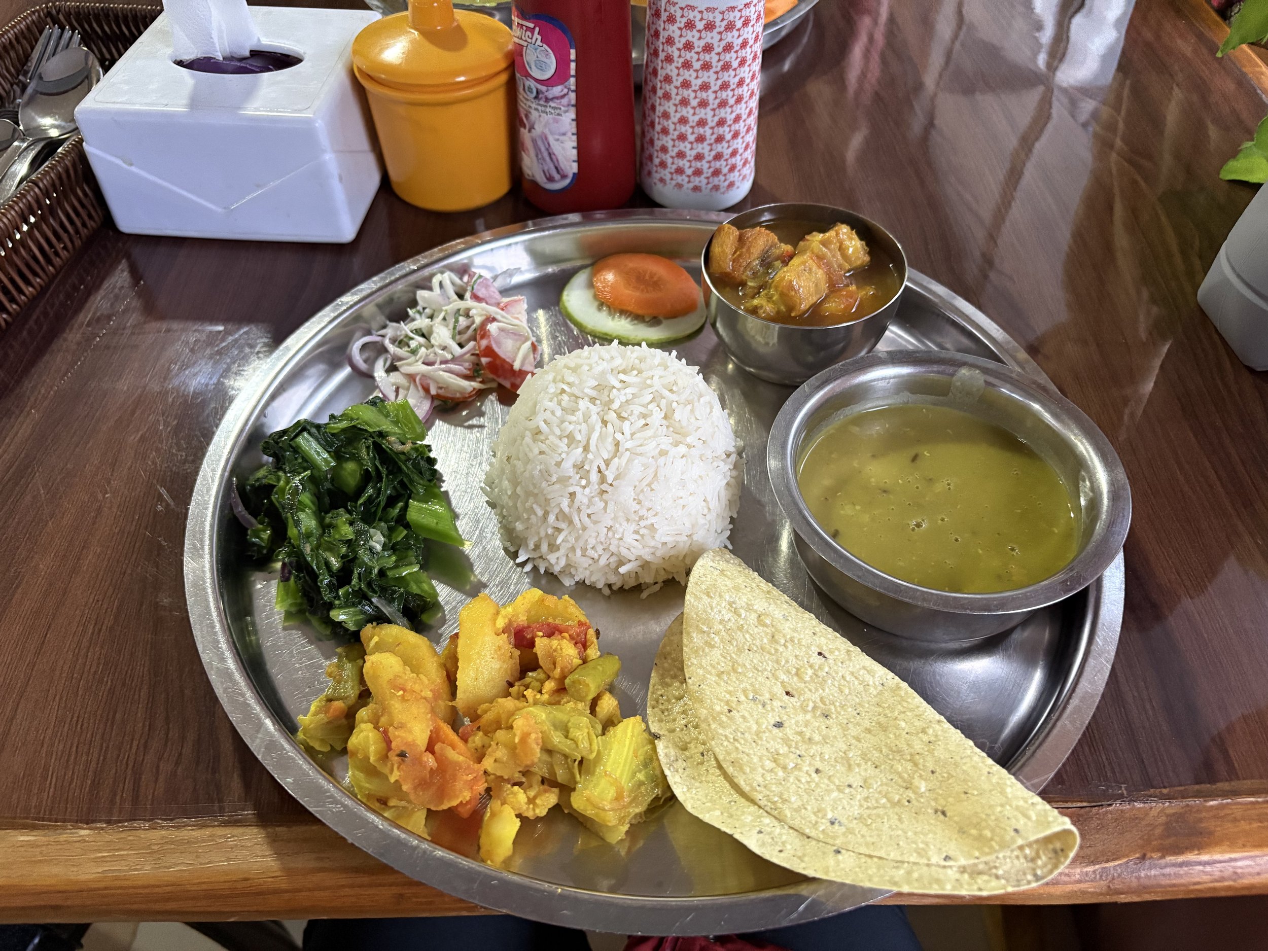 A traditional meal of dal bhat (rice and lentils) in Nepal.
