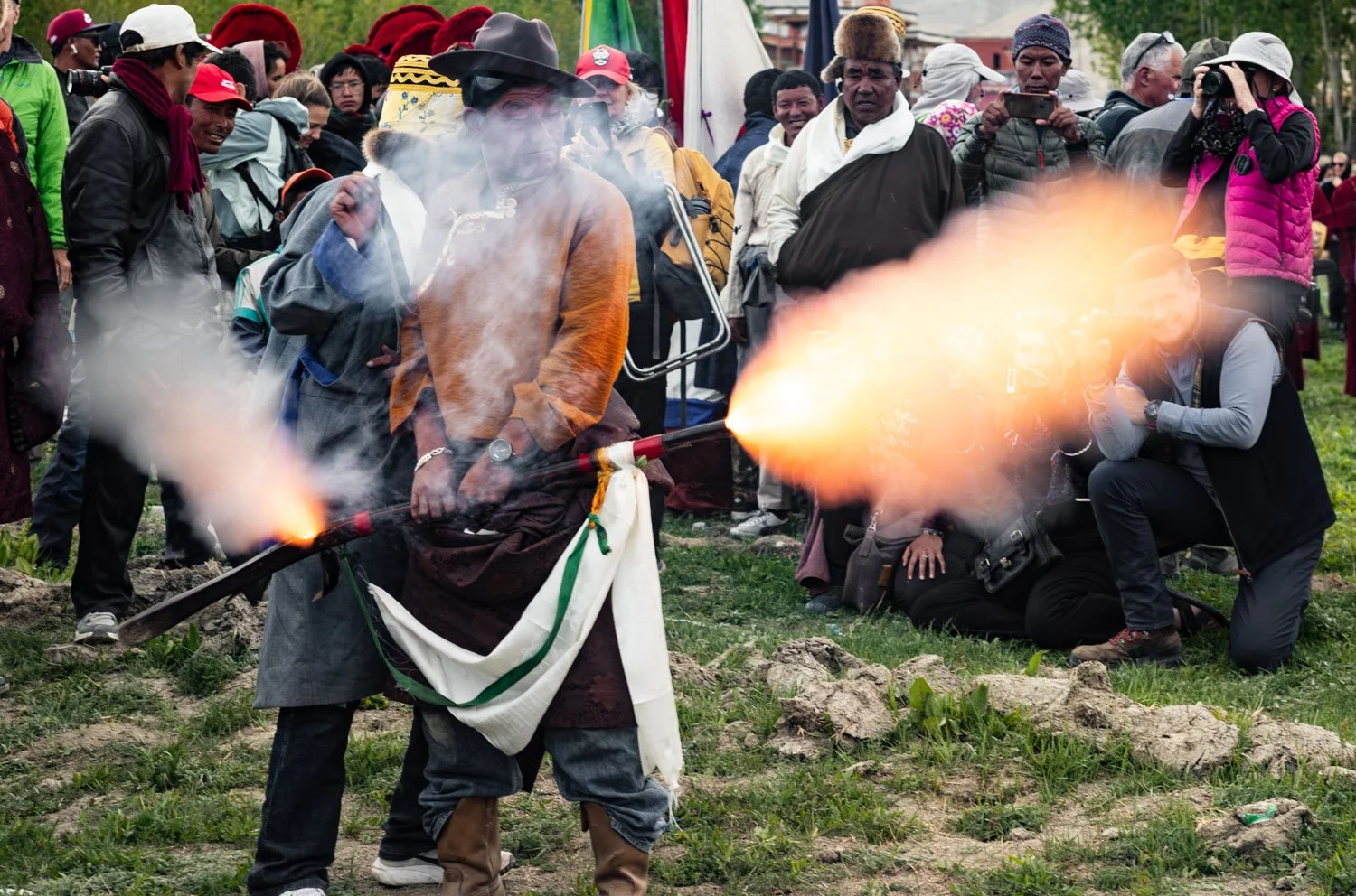Two men fire an ancient musket to signify the victory of good over evil