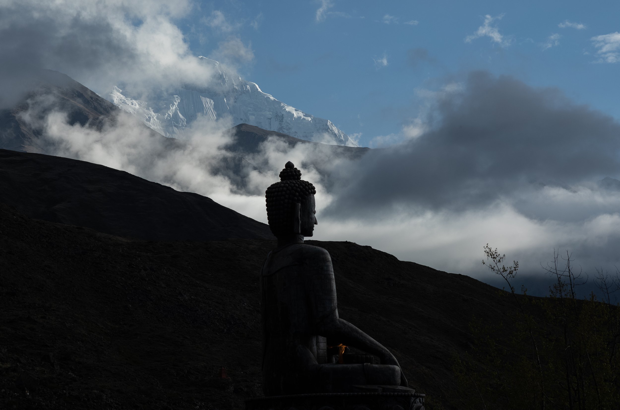 A Buddha statue in Muktinath looking west towards the Himalayas.
