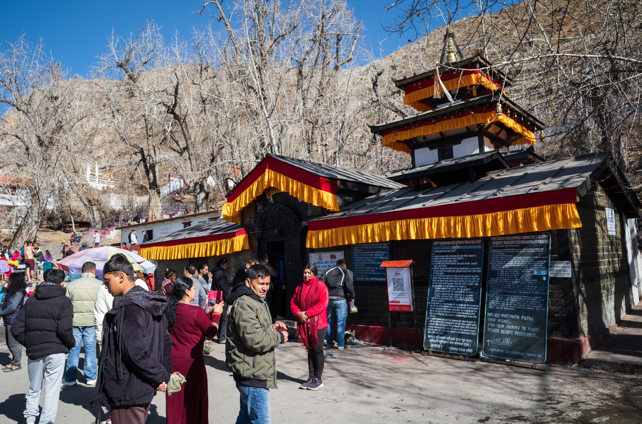 Crowds of Hindu devotees gather outside the innermost shrine of Muktinath Temple in Nepal.
